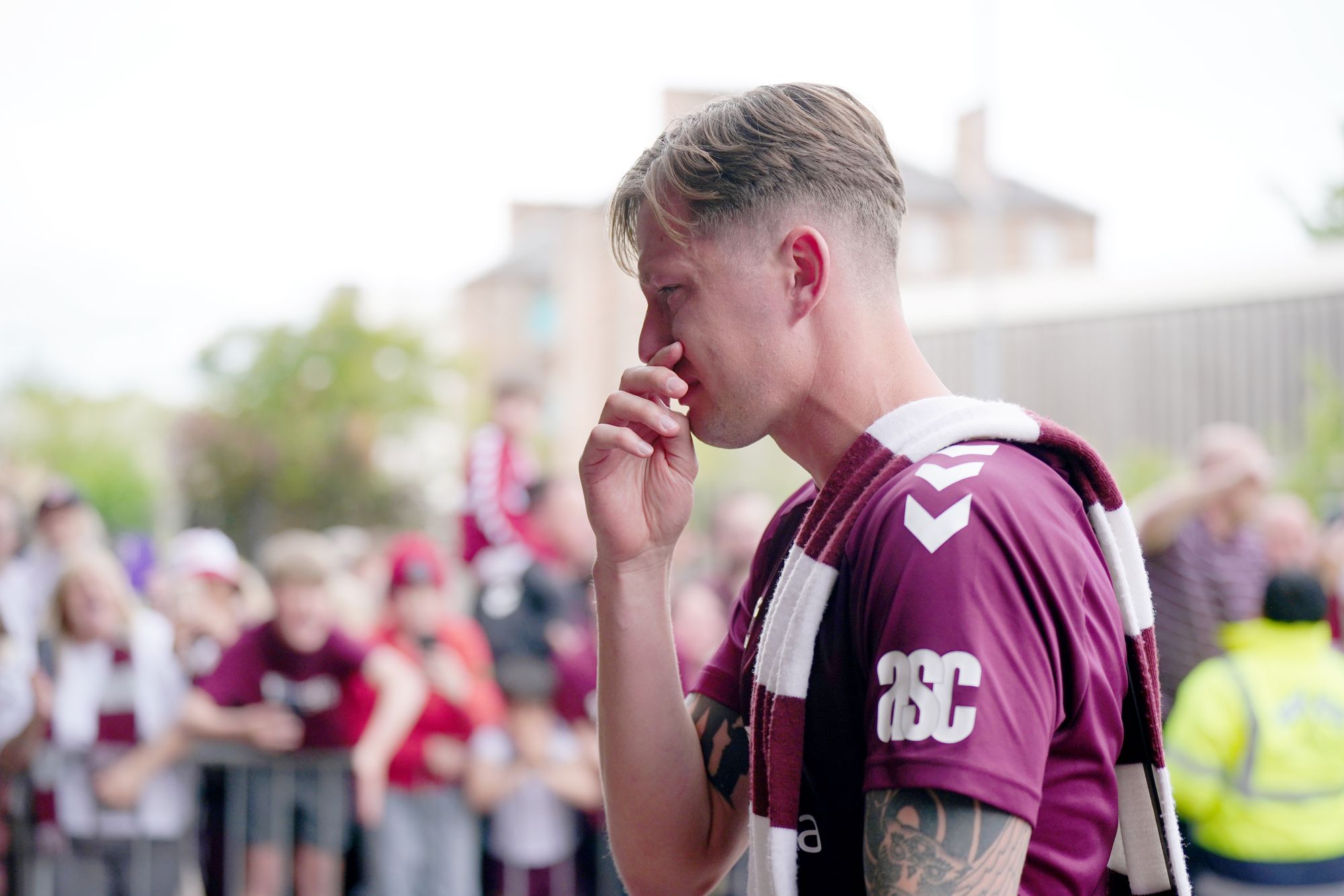 Heart of Midlothian player Frankie Kent becomes emotional as he walks past fans