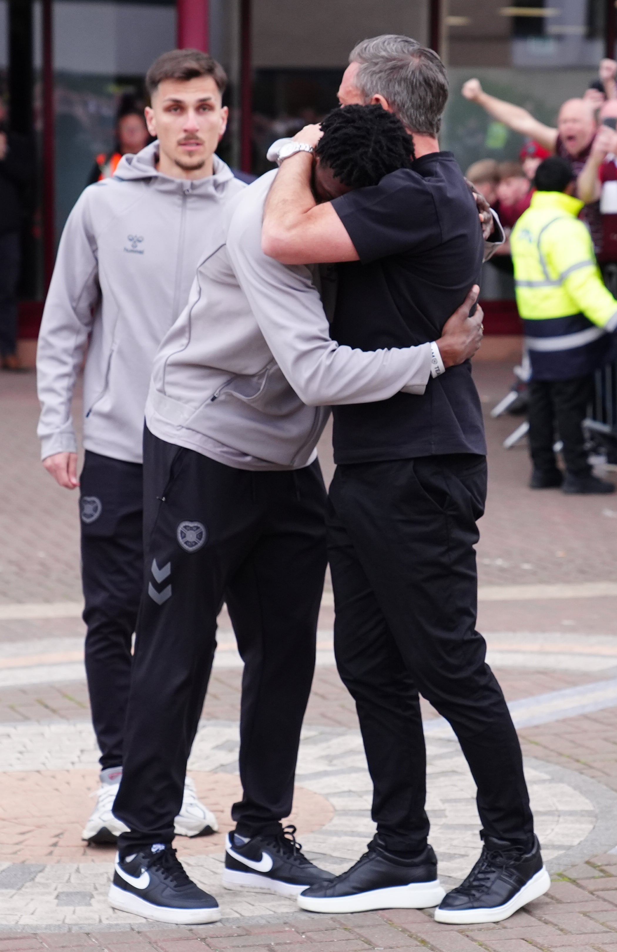 Heart of Midlothian manager Derek McInnes consoles a player as they come out to meet fans