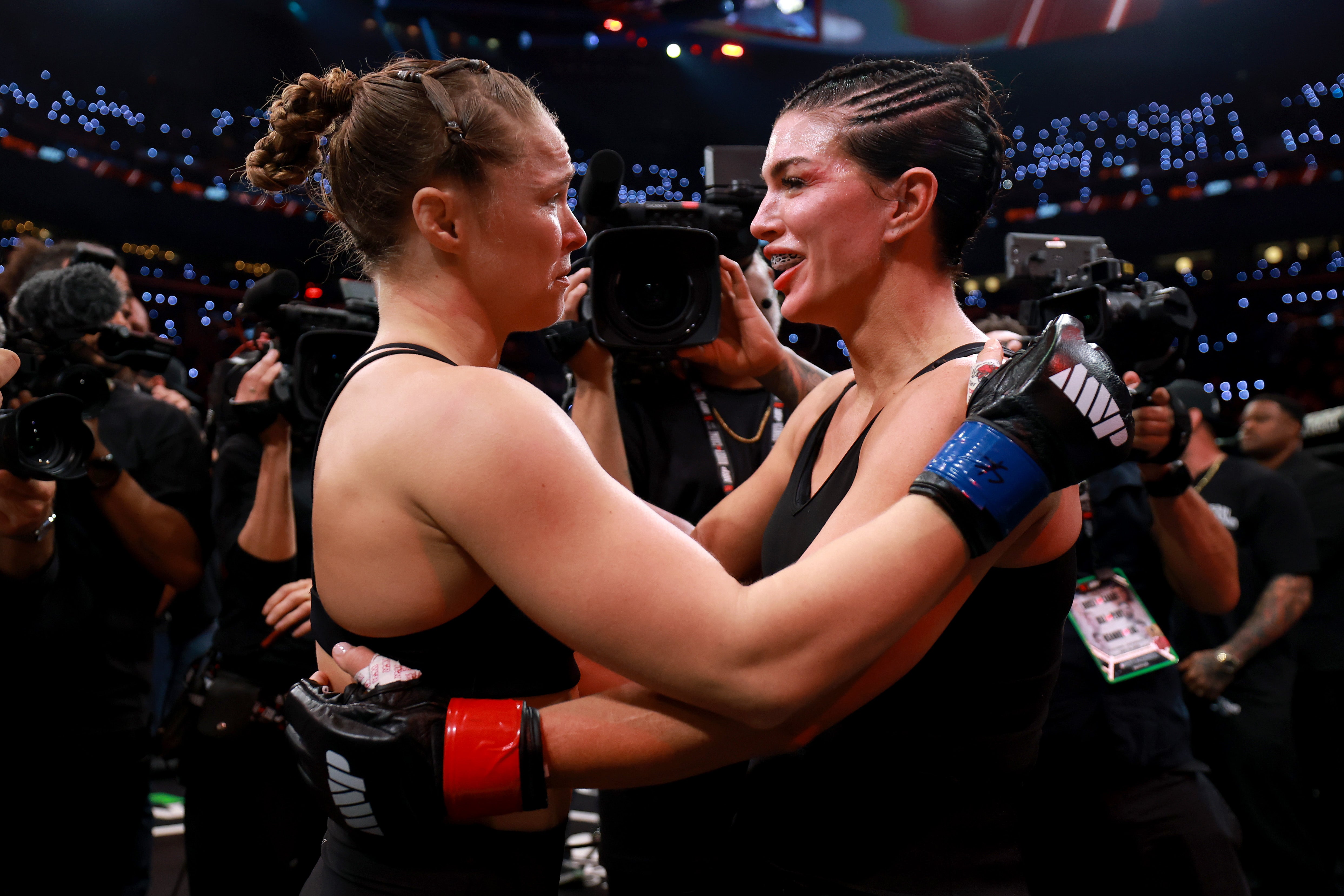 Rousey and Carano embracing after their fight in California