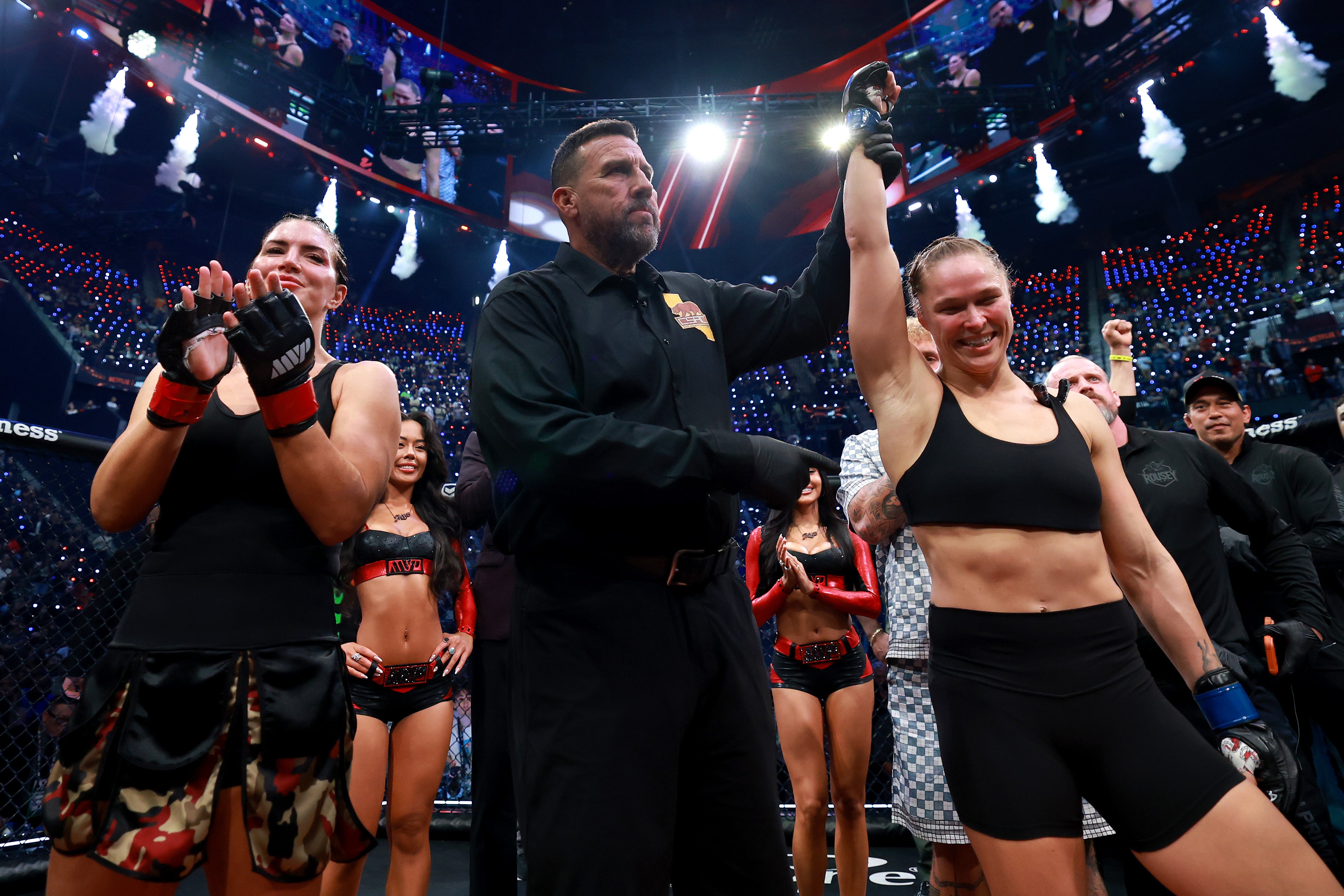 Ronda Rousey (right) has her hand raised after beating Gina Carano