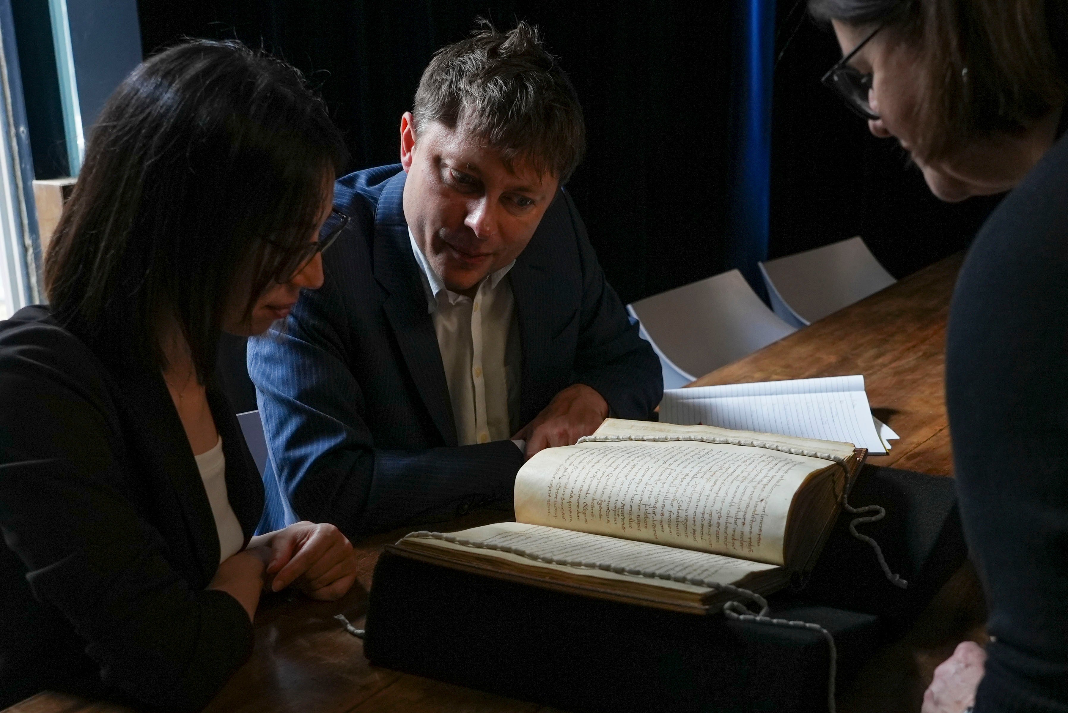 From left, Elisabetta Magnanti and Mark Faulkner from Dublin's Trinity College and Valentina Longo of Rome's National Central Library look at a manuscript containing a rare, long-lost copy of Caedmon's Hymn