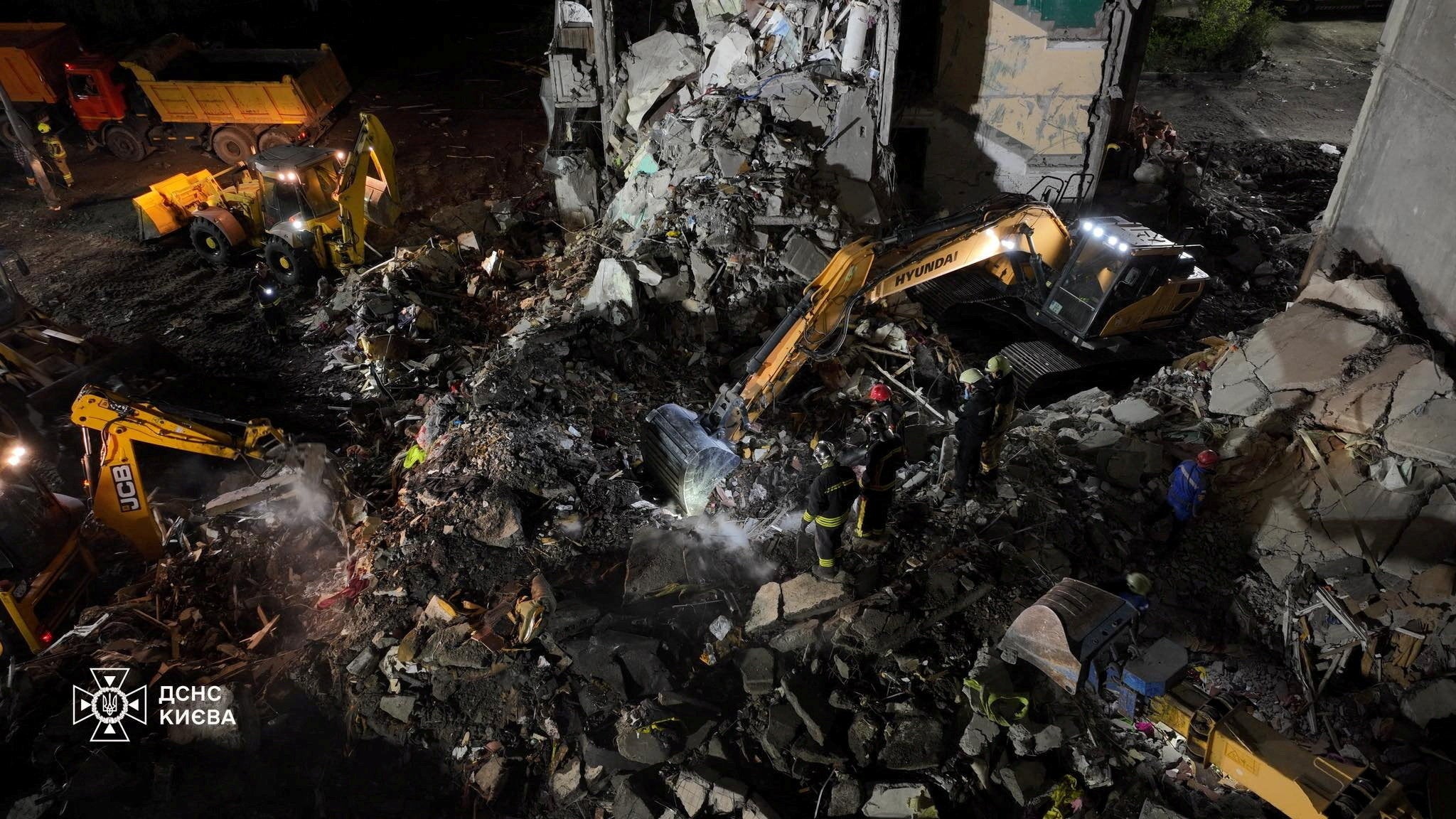 Firefighters work at the site of an apartment building damaged during Russian missile and drone strike