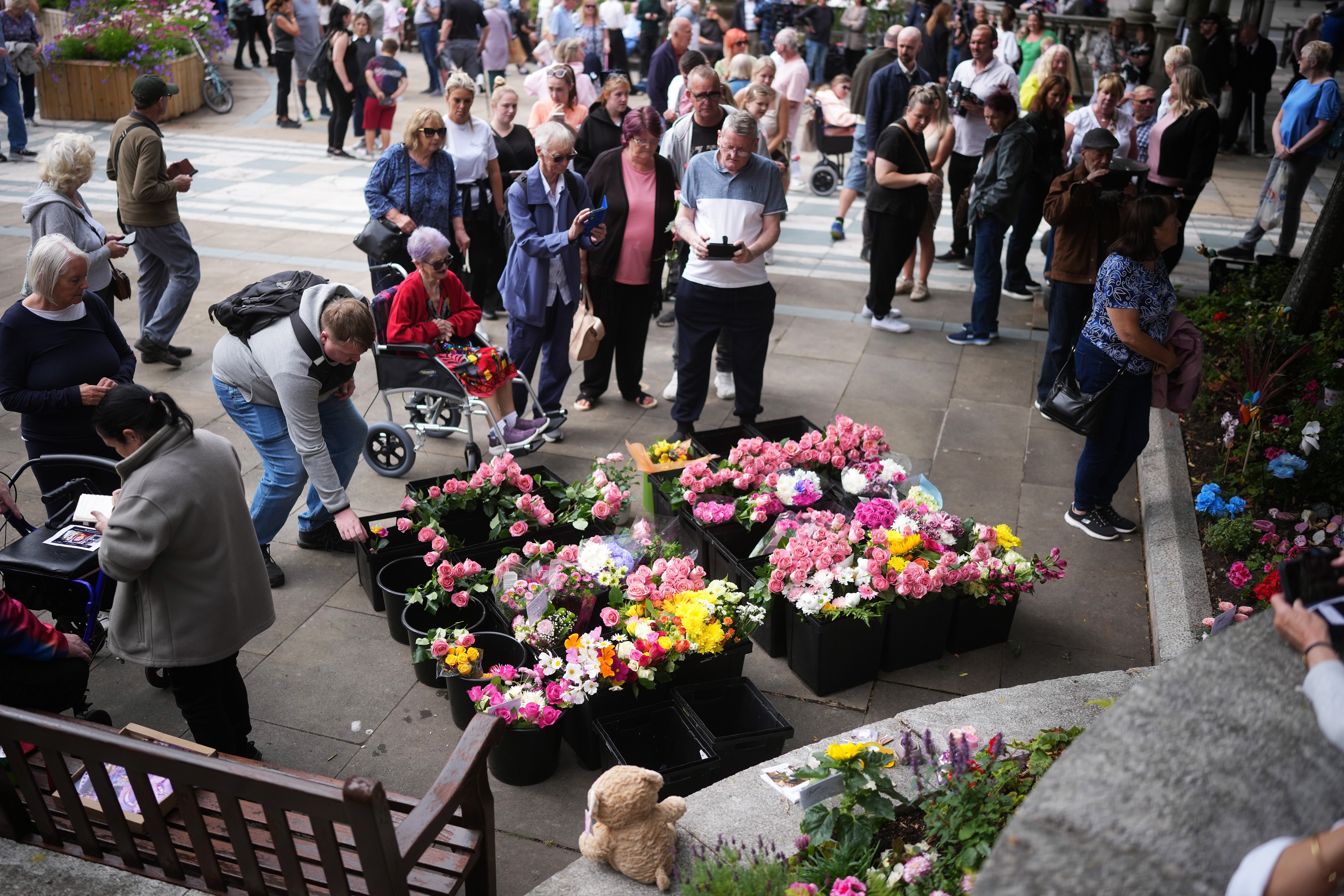 People bring tributes and flowers to lay outside The Atkinson on the first anniversary of the Southport stabbings. Elsie Dot Stancombe, 7, Bebe King, 6, and Alice da Silva Aguiar, 9, died in the horror attack in July 2025