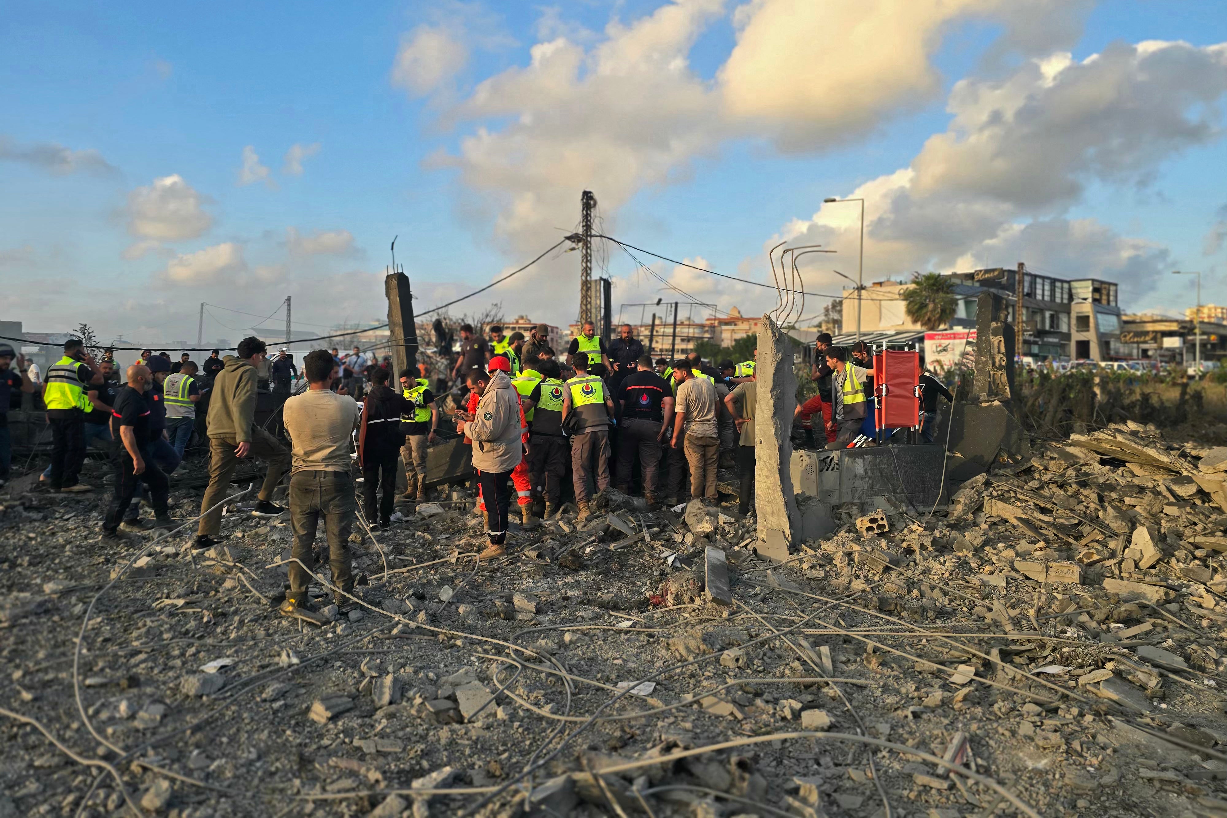 First responders gather at the site of an Israeli airstrike that targeted an area in the suburbs of the southern Lebanon coastal city of Tyre on May 16