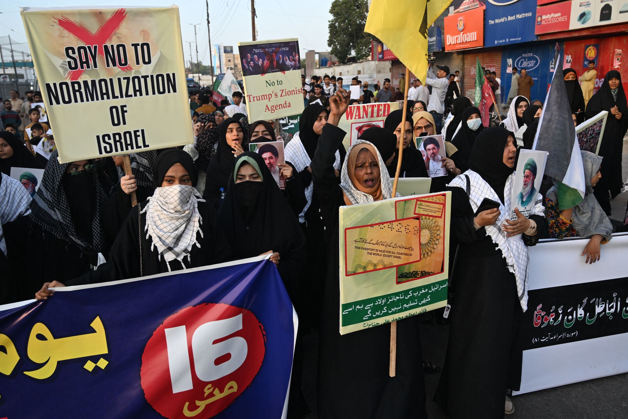 Placards in held by protestors read 