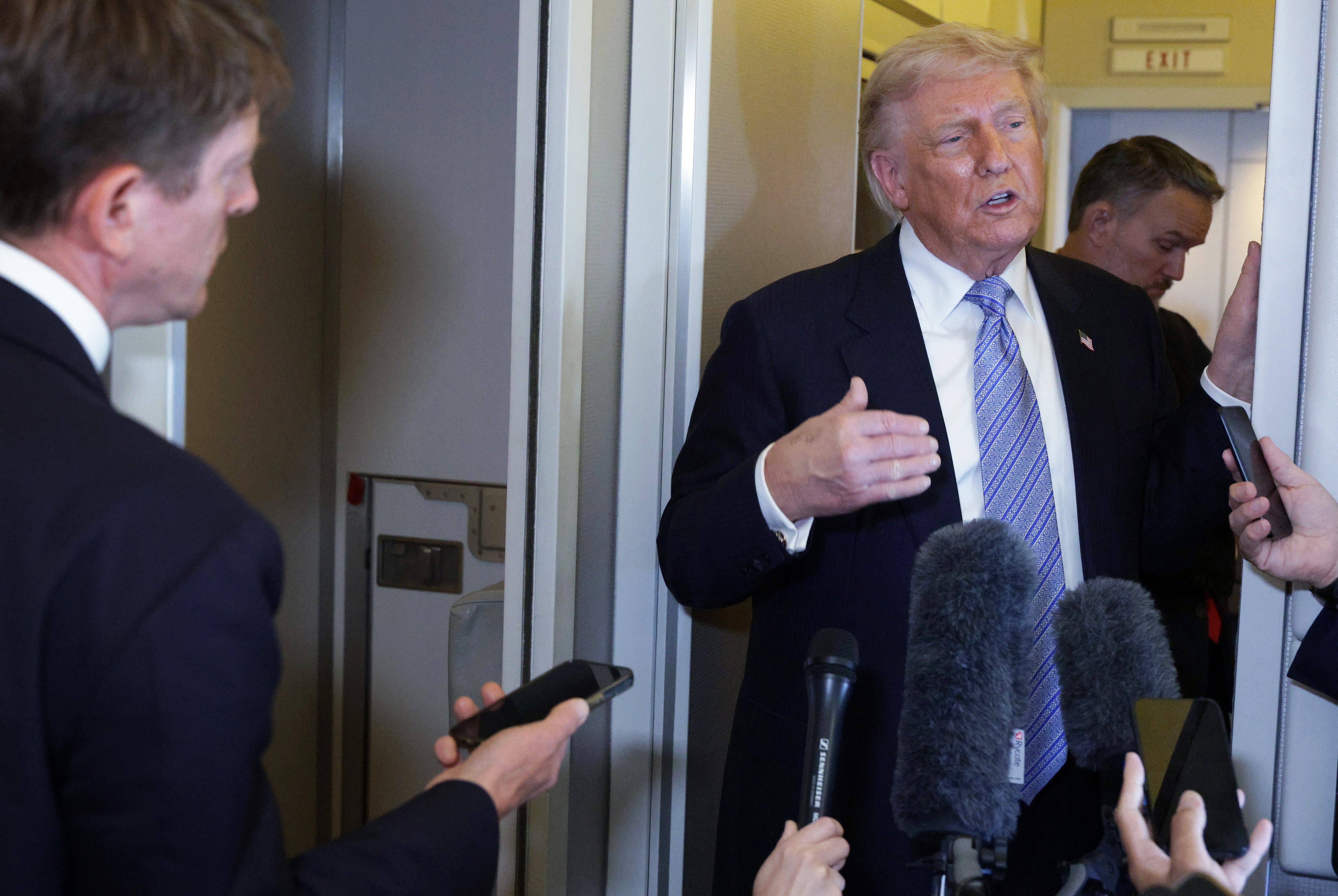 Trump speaks to the media aboard Air Force One