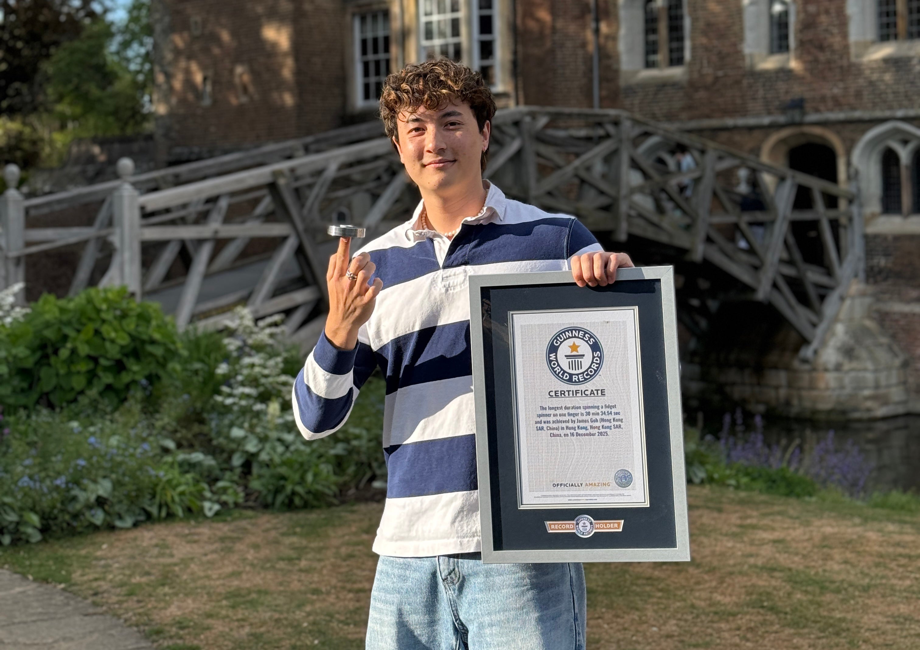 James Goh breaks the world record for spinning a fidget spinner on one finger for the longest time