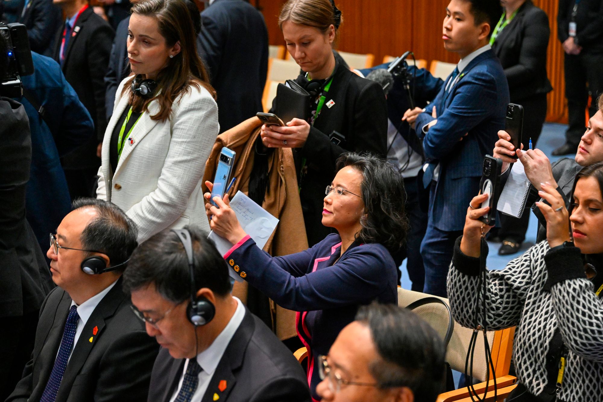 Cheng Lei, center, films a signing ceremony with Chinese Premier Li Qiang and Australian Prime Minister Anthony Albanese