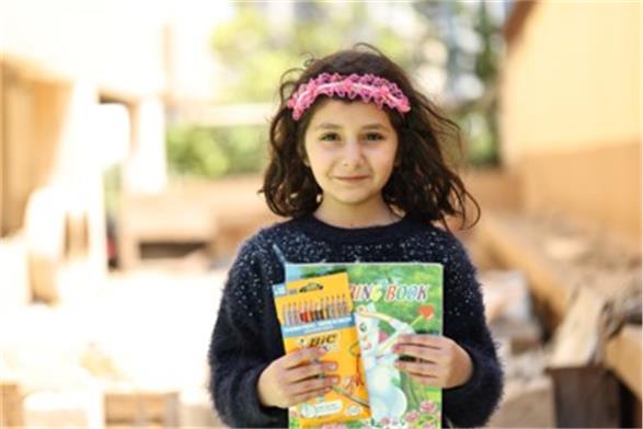 Naya, 6, enjoys using her colouring book, but wants to start learning again