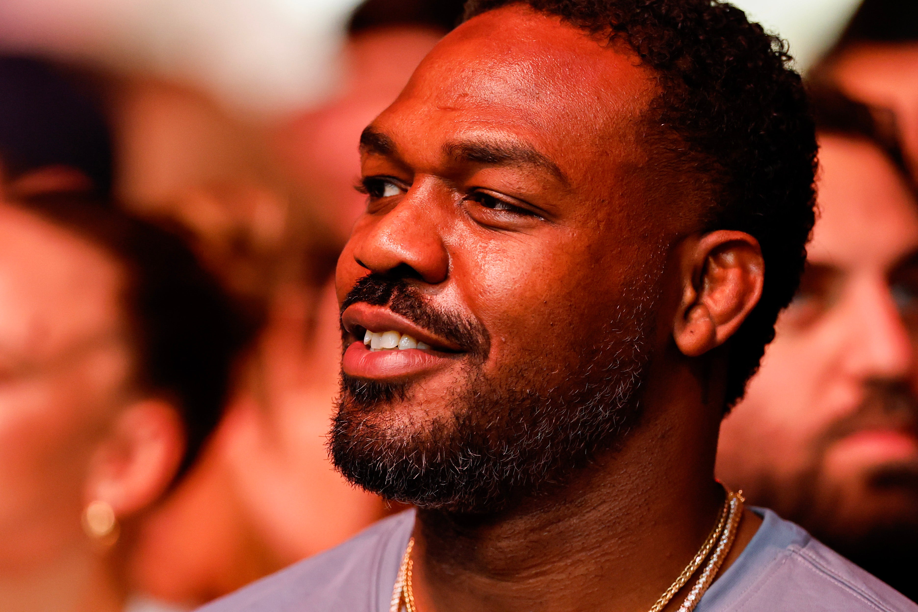 Jon Jones sitting cageside at UFC 327 in April