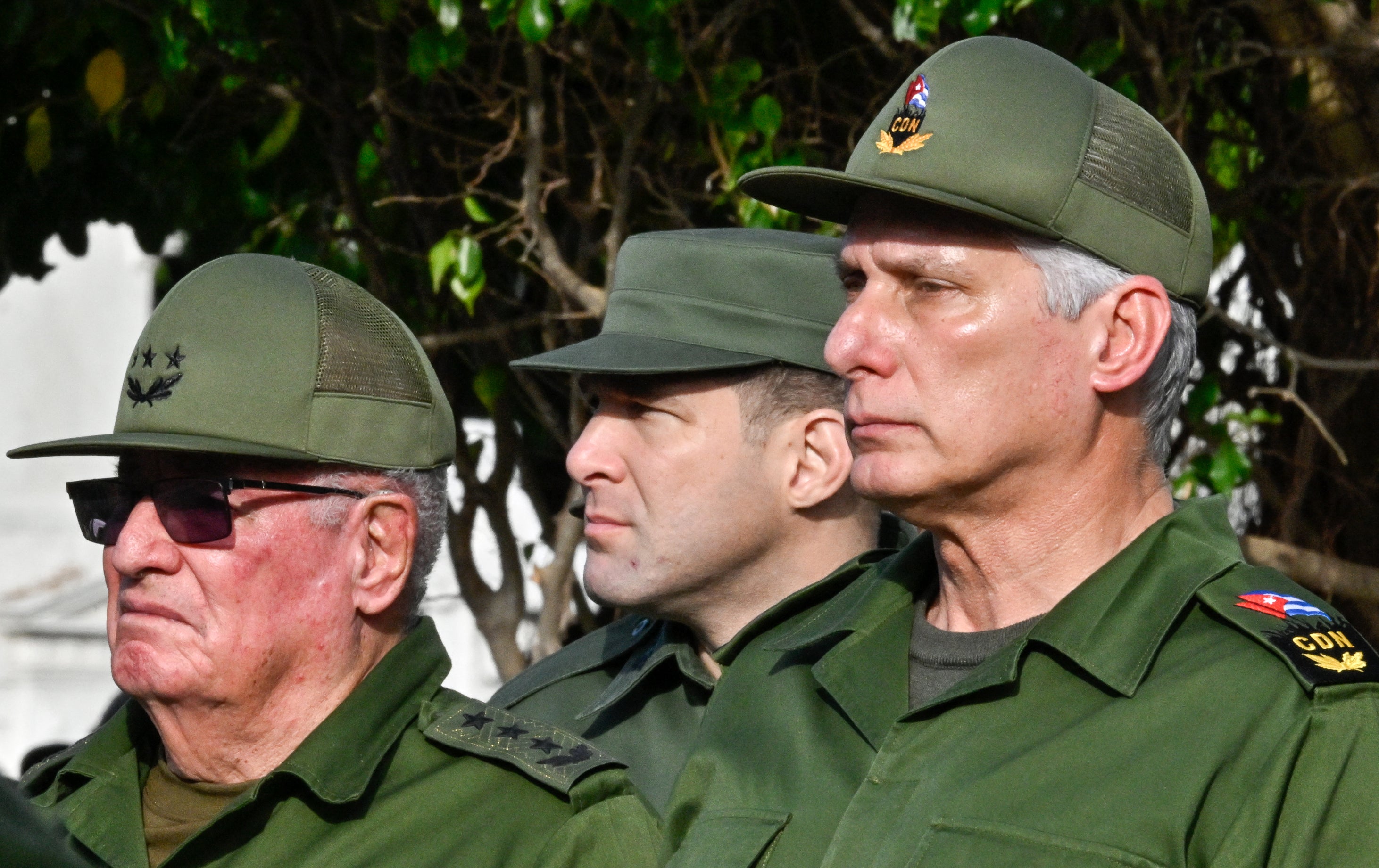 Cuba's President Miguel Diaz-Canel (R), Colonel Raul Guillermo Rodriguez Castro (C),  grandson of former President Raul Castro, and Armed Forces Minister General Alvaro Lopez Miera attend the funeral of the 32 Cuban soldiers killed during the US incursion in Venezuela (AFP/Getty)