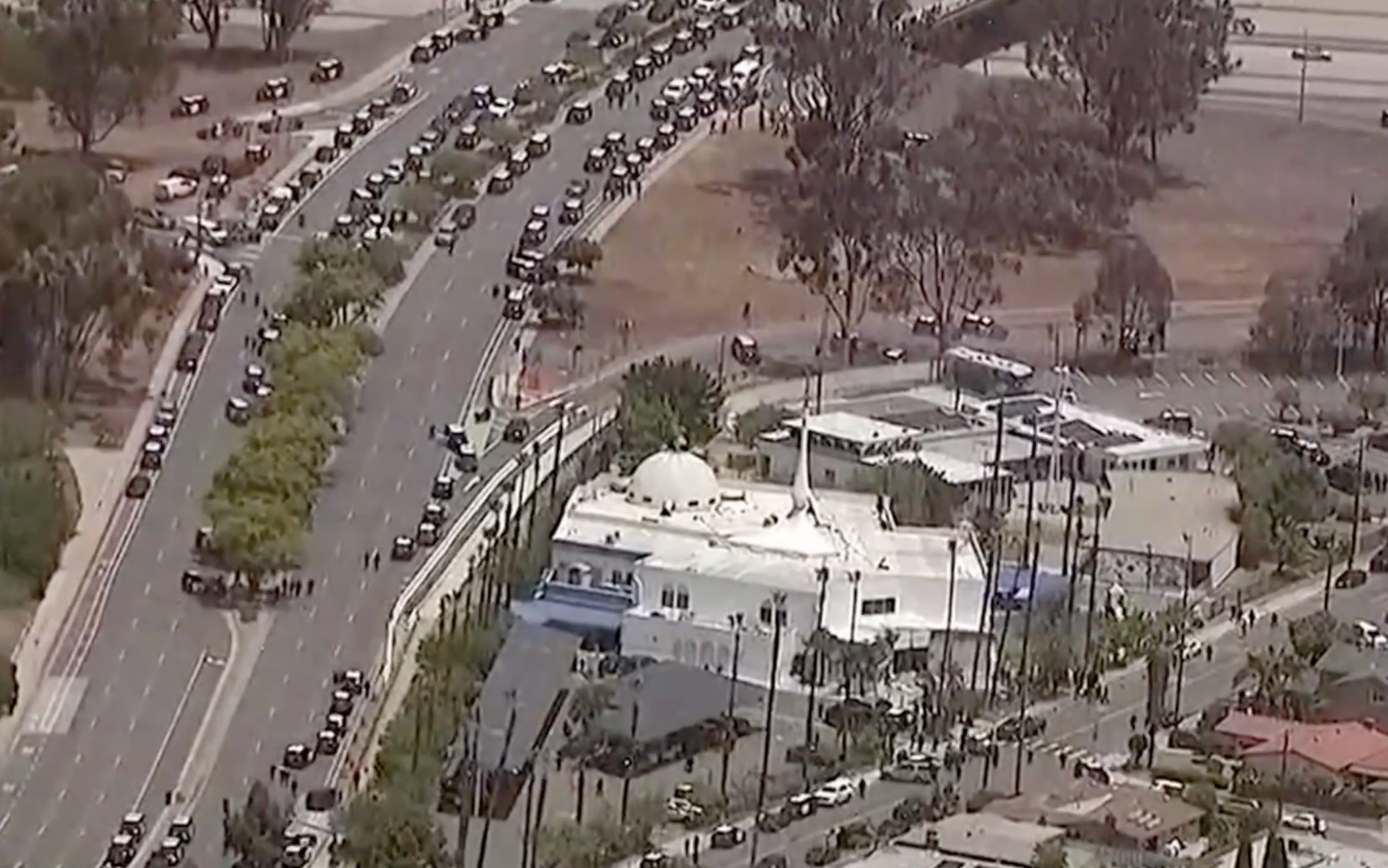 Aerial footage shows dozens of police vehicles lining a road near the Islamic center