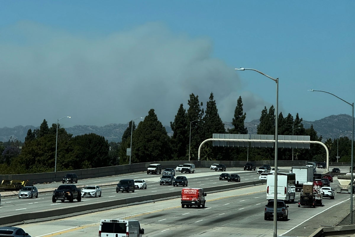 Fast-growing brush fire in Southern California threatens homes