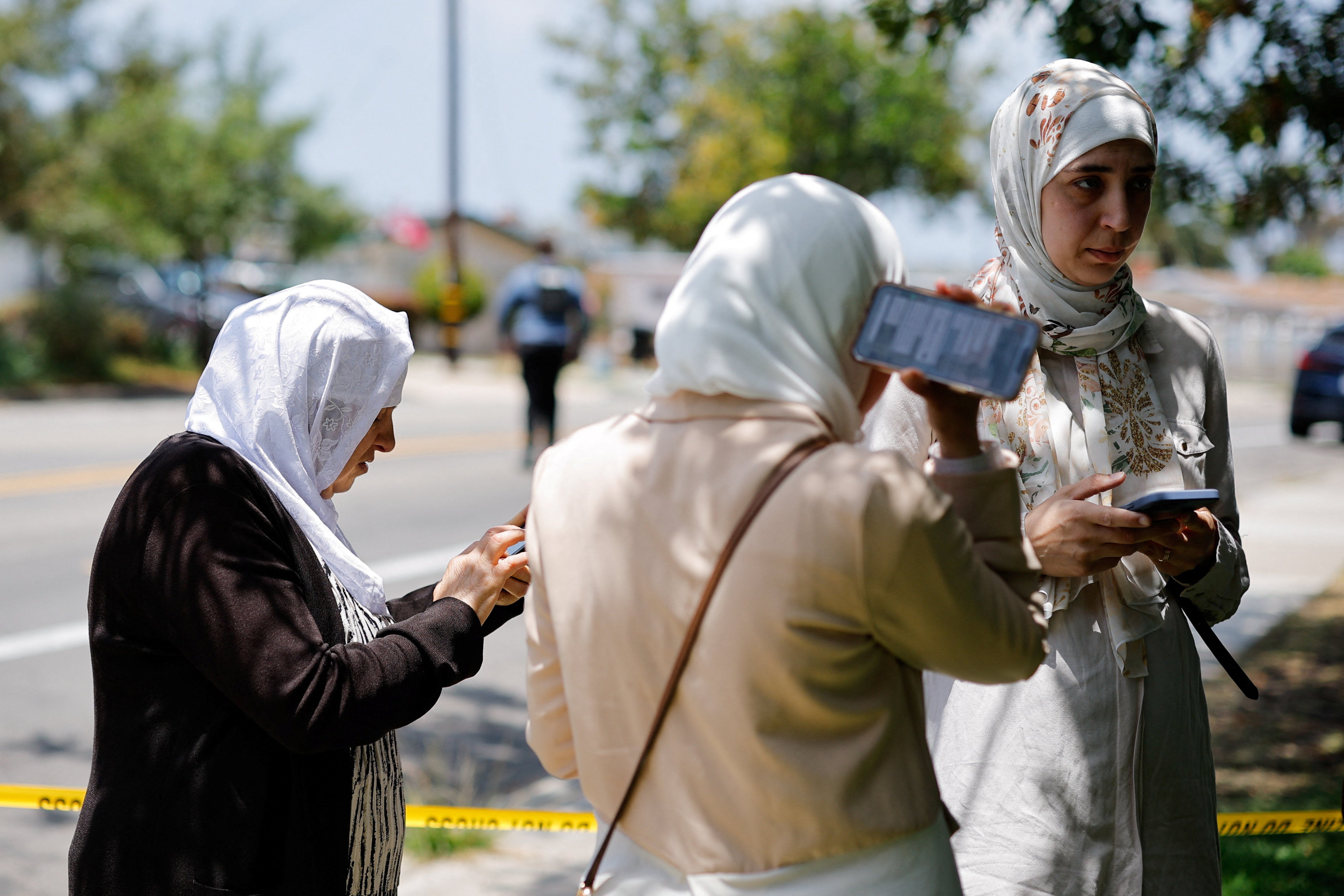Members of the Muslim community were seen using their phones at the scene of a reported active shooter situation at the Islamic Center