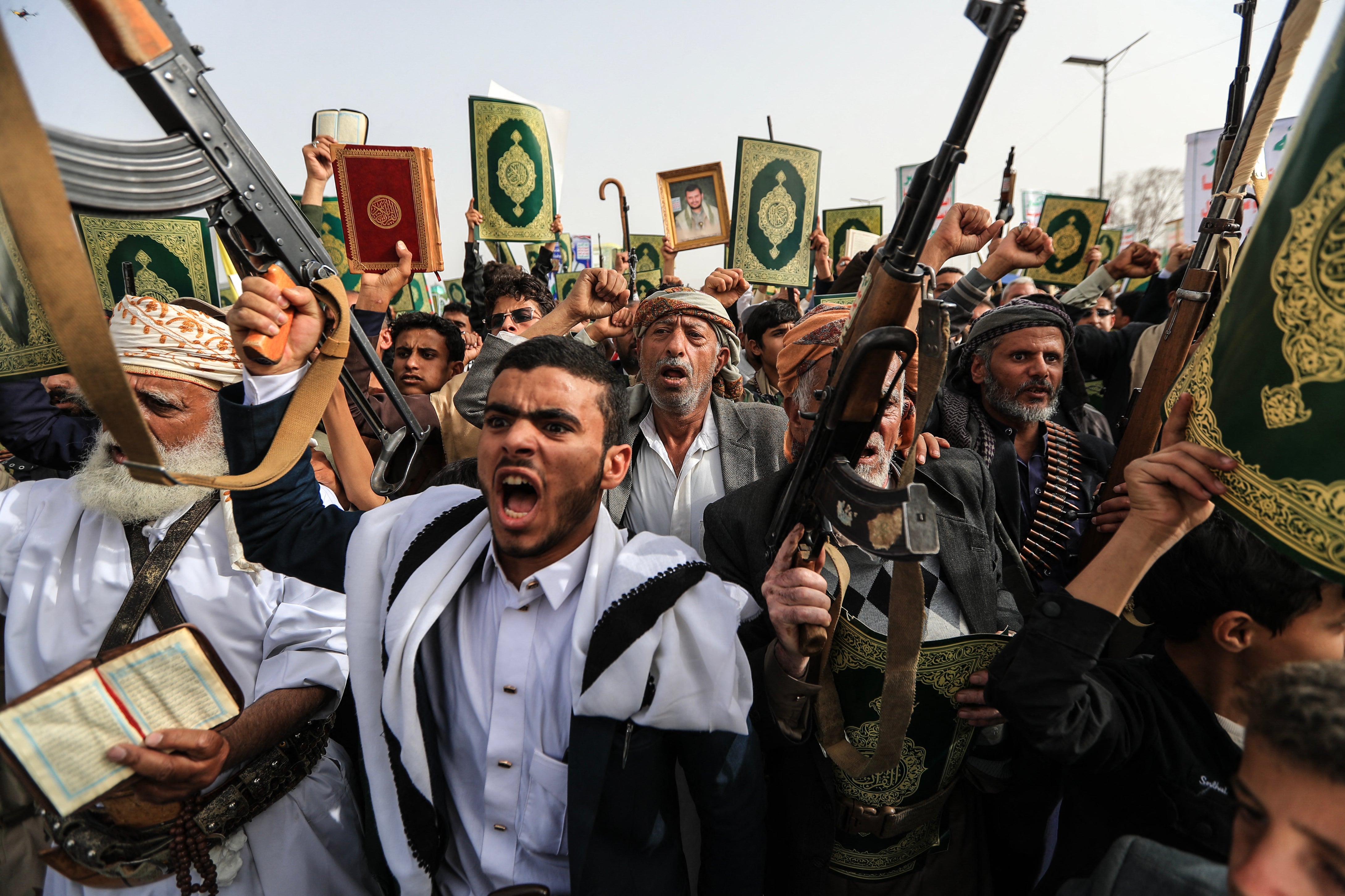 Supporters of the Iran-backed Houthi movement brandish weapons and copies of the Quran as they rally in solidarity with Lebanon in Sanaa on May 18, 2026 (AFP/Getty)