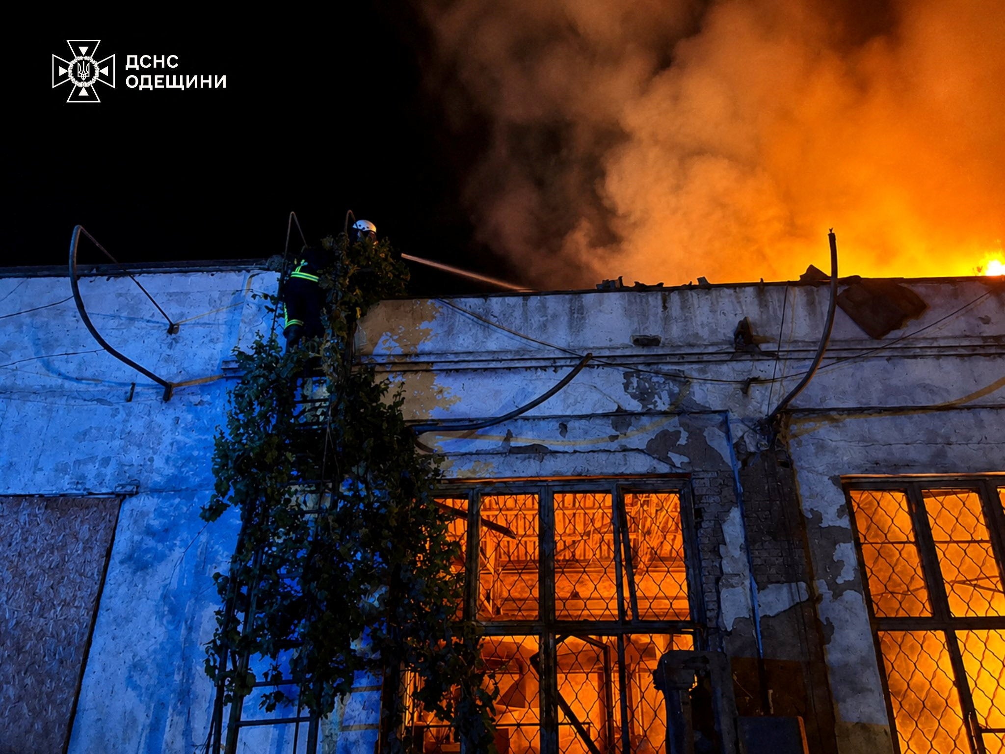 A firefighter works at a compound of a port which was hit during overnight Russian drone strikes in the town of Izmail in Odesa