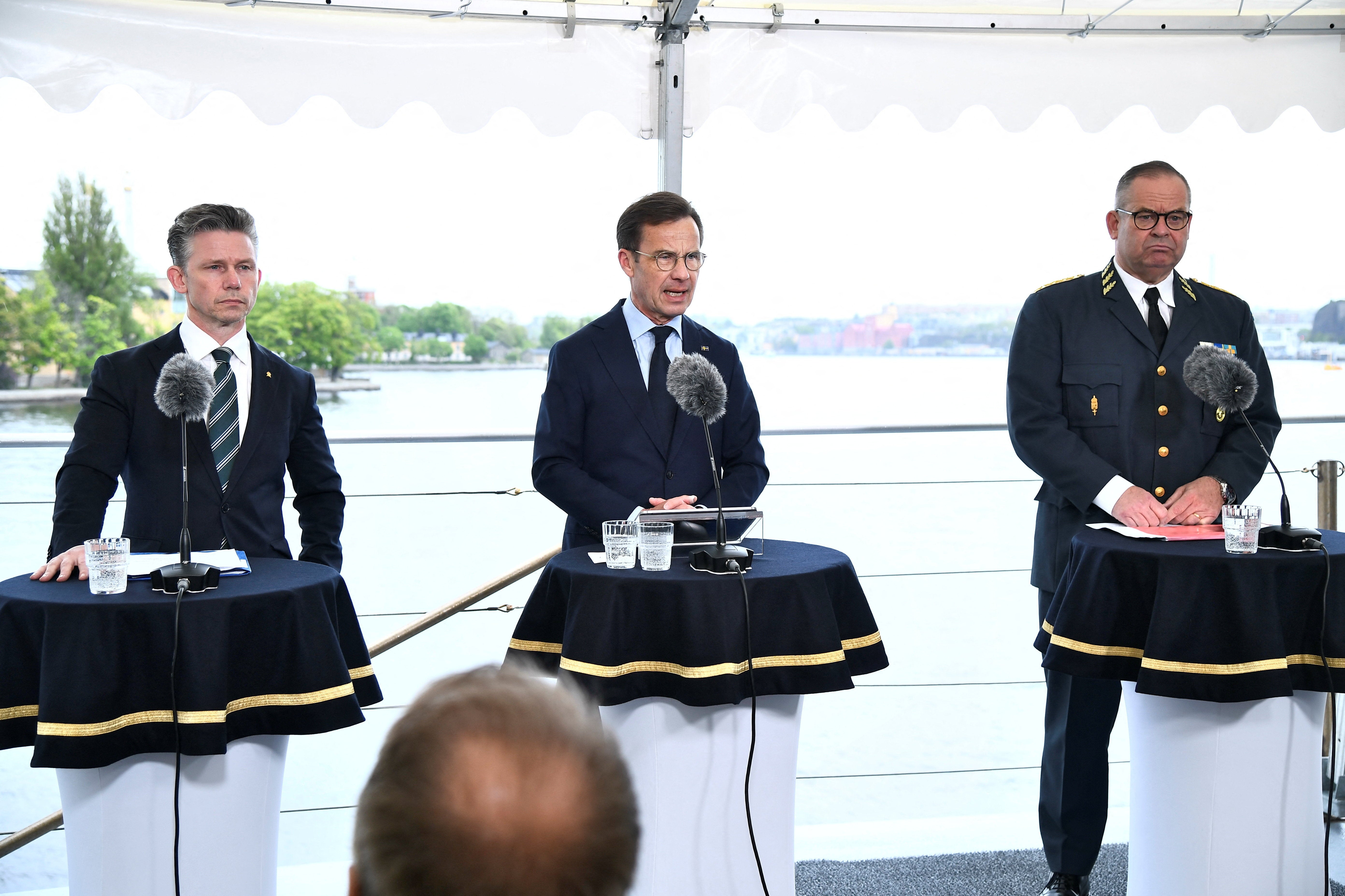 Sweden's Minister for Defence Pal Jonson, Prime Minister Ulf Kristersson, and Supreme Commander Michael Claesson attend a press conference aboard the Visby-class corvette HMS Harnosand in Stockholm, Sweden