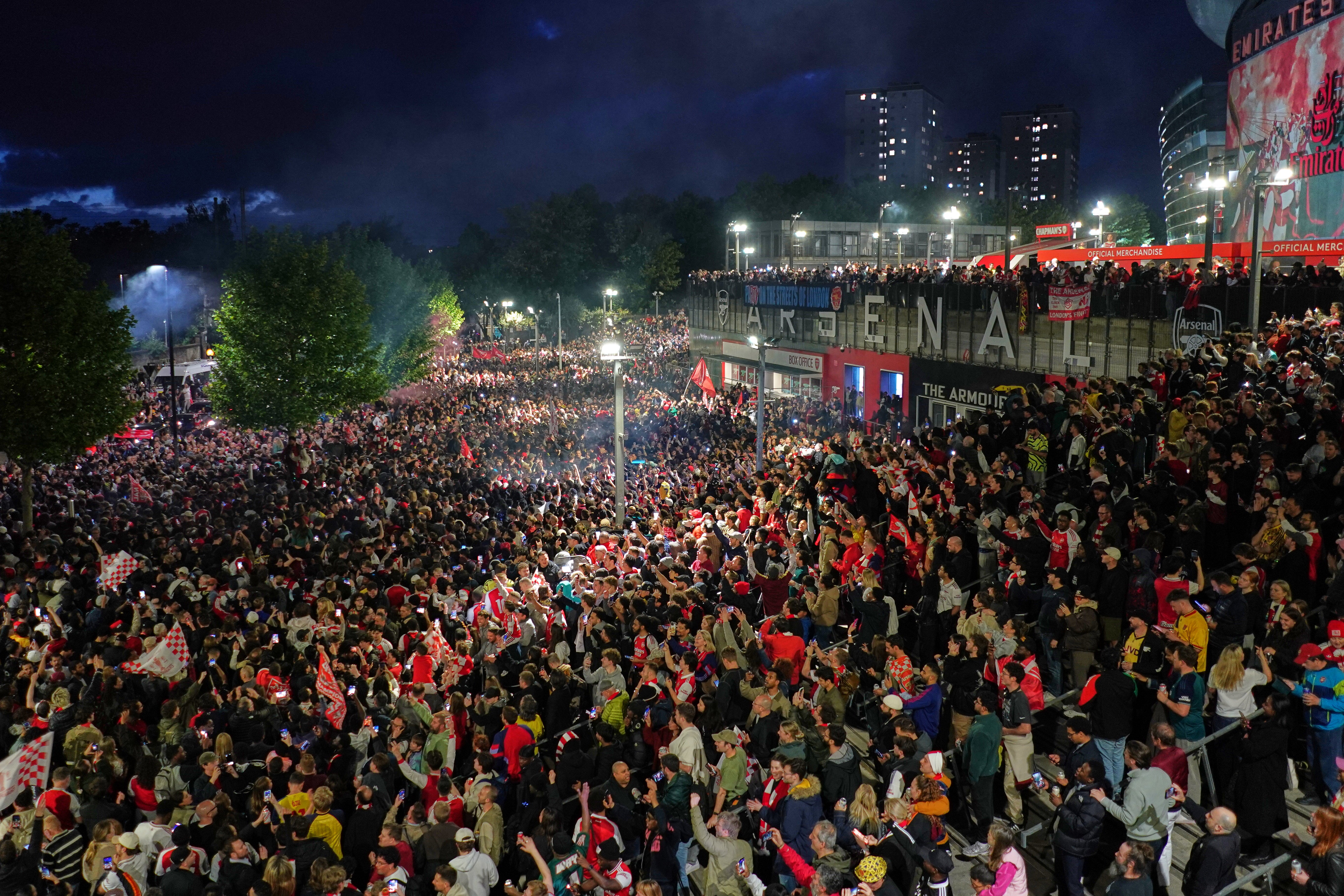 Arsenal supporters gather at the Emirates Stadium to celebrate winning the title