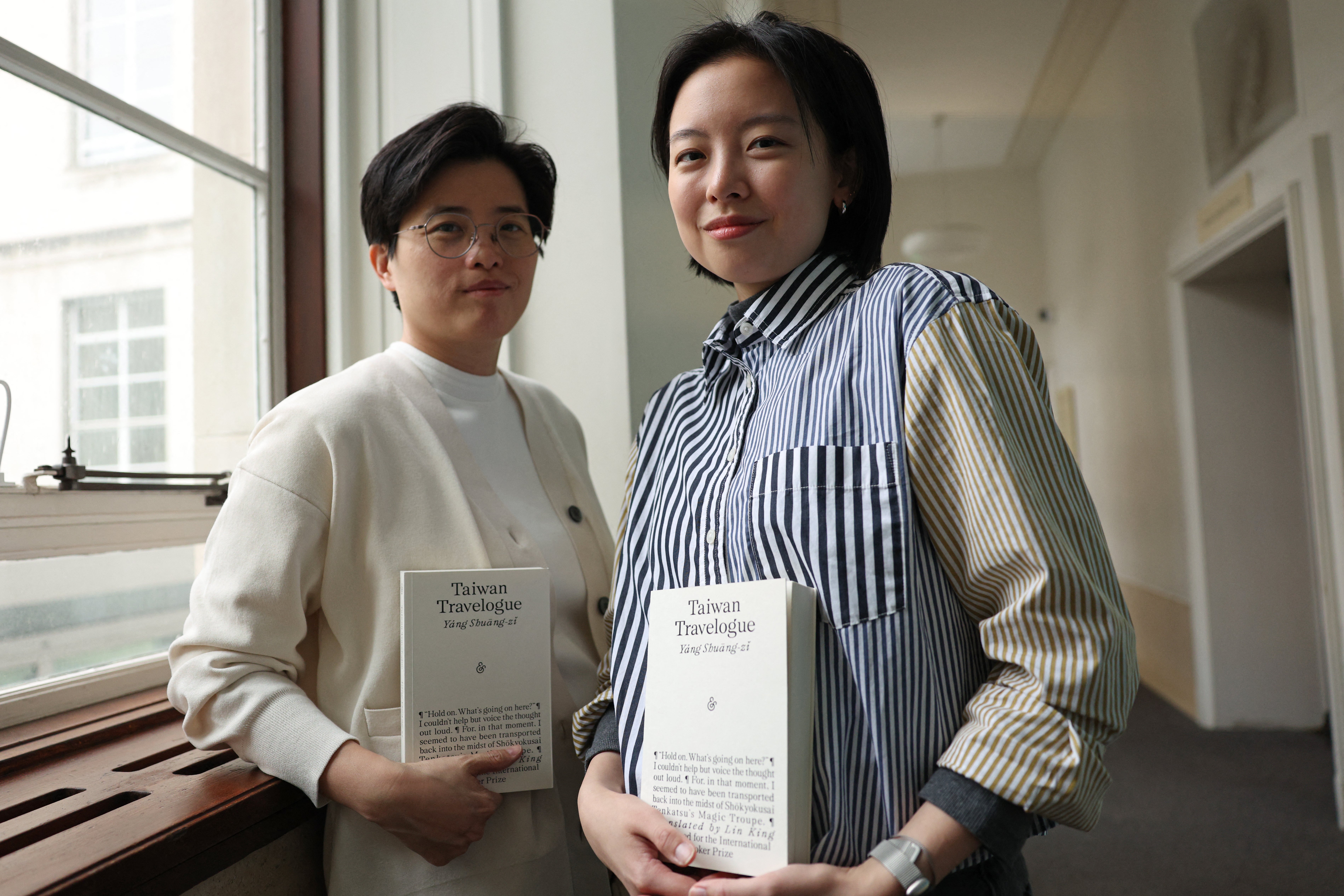 Taiwanese writer Yang Shuang-zi (left) poses with her book 'Taiwan Travelogue' beside her translator Lin King (AFP/Getty)