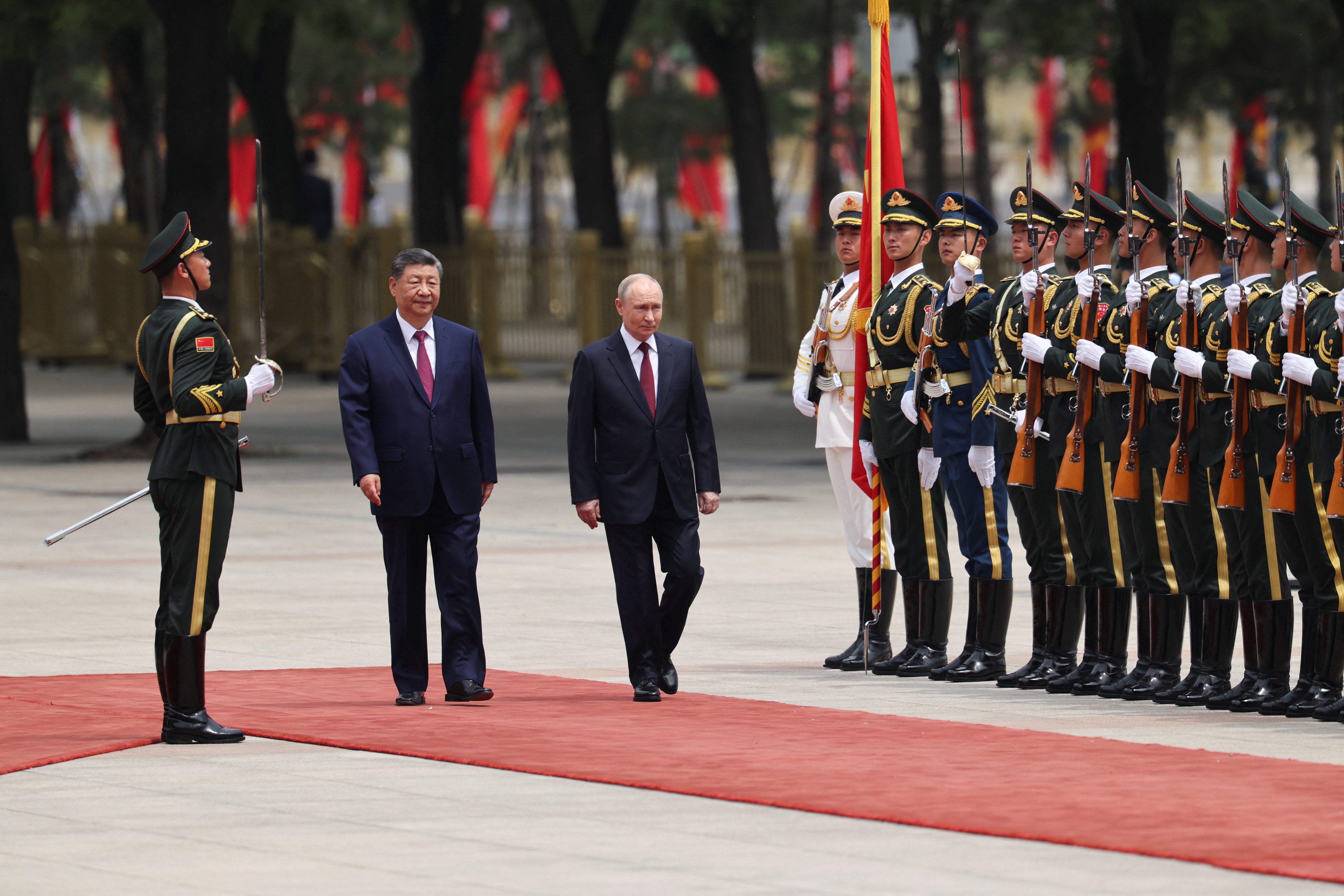 Russian president Vladimir Putin and Chinese president Xi Jinping inspect an honor guard during a welcoming ceremony at the Great Hall of the People in Beijing (Reuters)