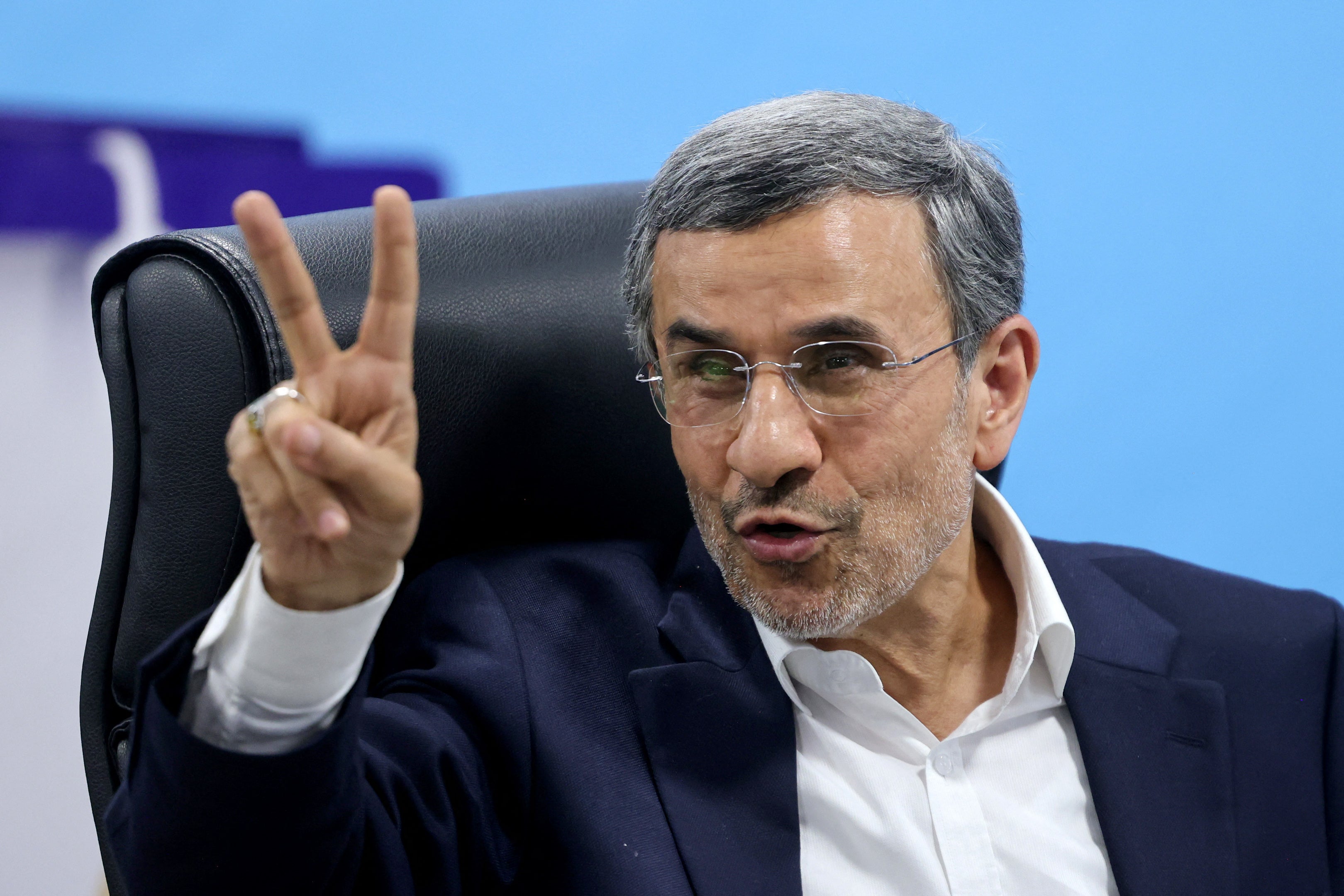 Former Iranian president Mahmoud Ahmadinejad flashes the V-sign for victory after registering his candidacy for Iran's presidential election in Tehran on June 2, 2024