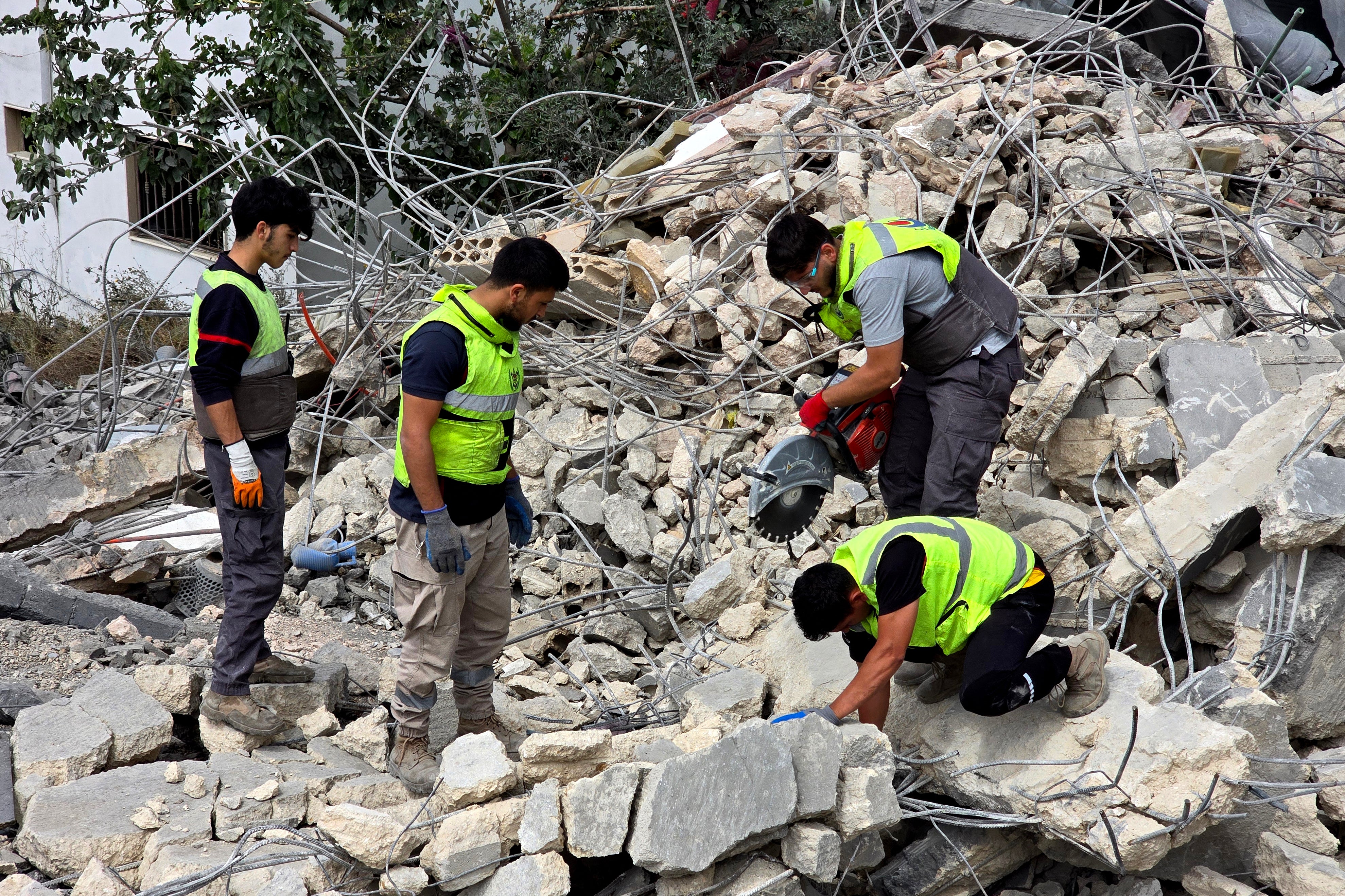 Lebanese civil defence workers search through the rubble in the southern Lebanese village of Deir Qanun al-Nahr on May 20, 2026, a day after Israeli strikes. (AFP/Getty)