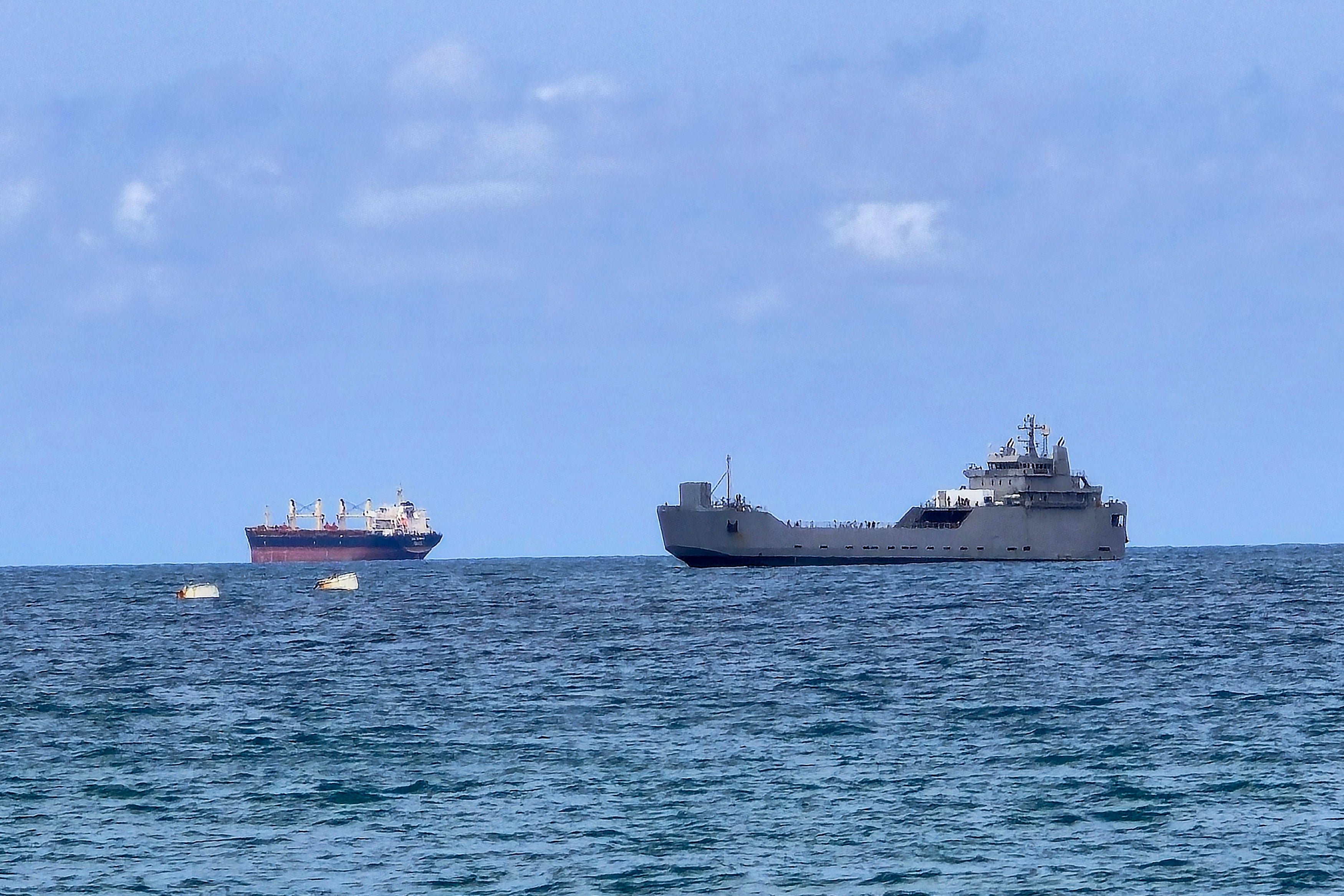 An Israeli naval vessel (R) is motored towards the Israeli port of Ashdod, about 40 kilometres south of Tel Aviv, on May 20, 2026, after Israeli forces intercepted the Gaza-bound Global Sumud Flotilla. (AFP/Getty)