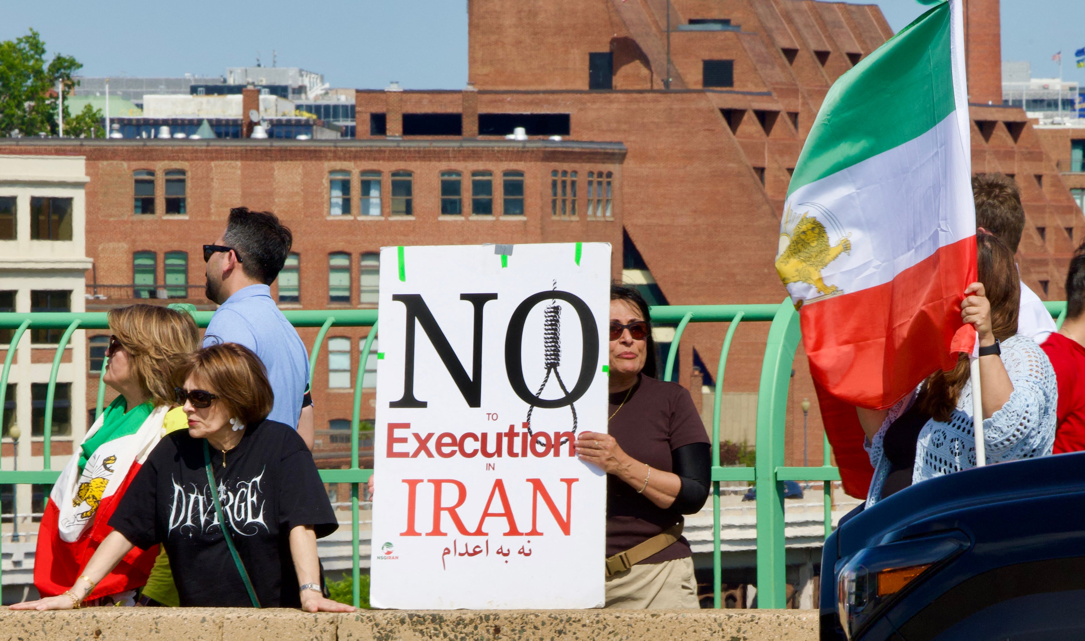 Demonstrators hold to condemn the execution of political prisoners in Iran on the Francis Scott Key Bridge in Washington, DC.