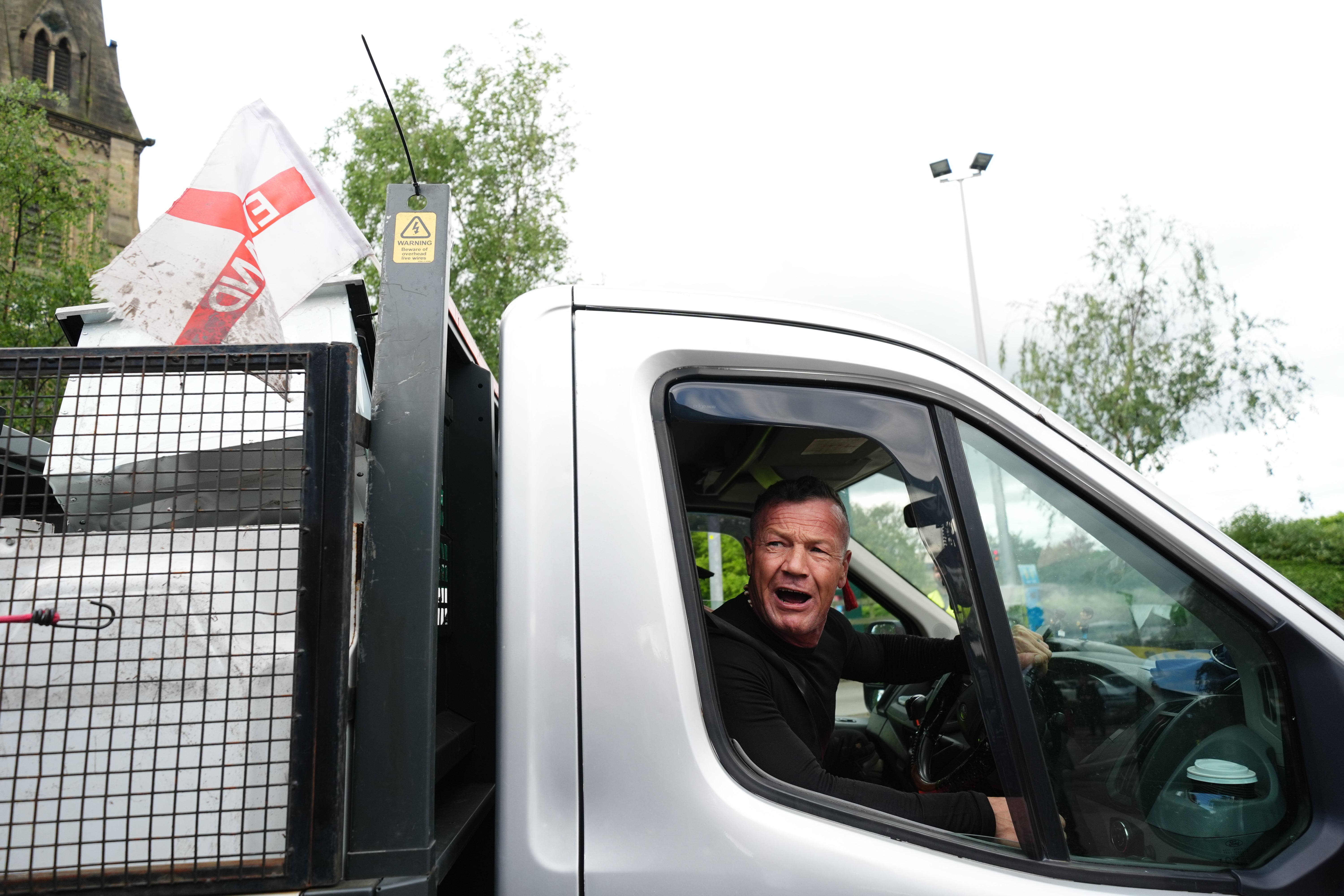 Rachel Reeves was interrupted by a man driving a truck with two St George’s flags on the roof while she gave a broadcast interview at a petrol station in Leeds on Wednesday (PA)