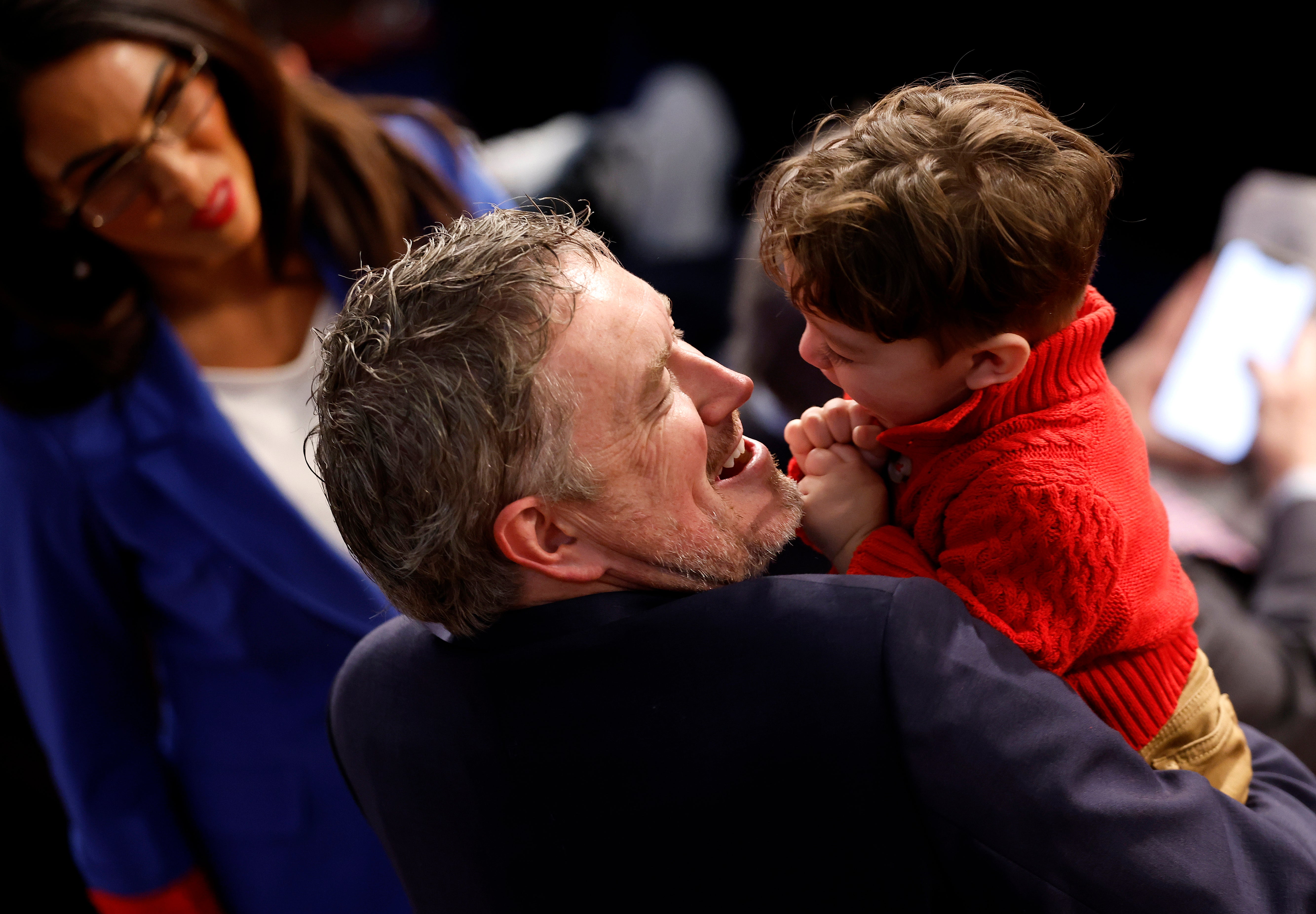 Thomas Massie talks to Lauren Boebert as he holds her grandchild Tyler on the first day of the 119th Congress in January 2025