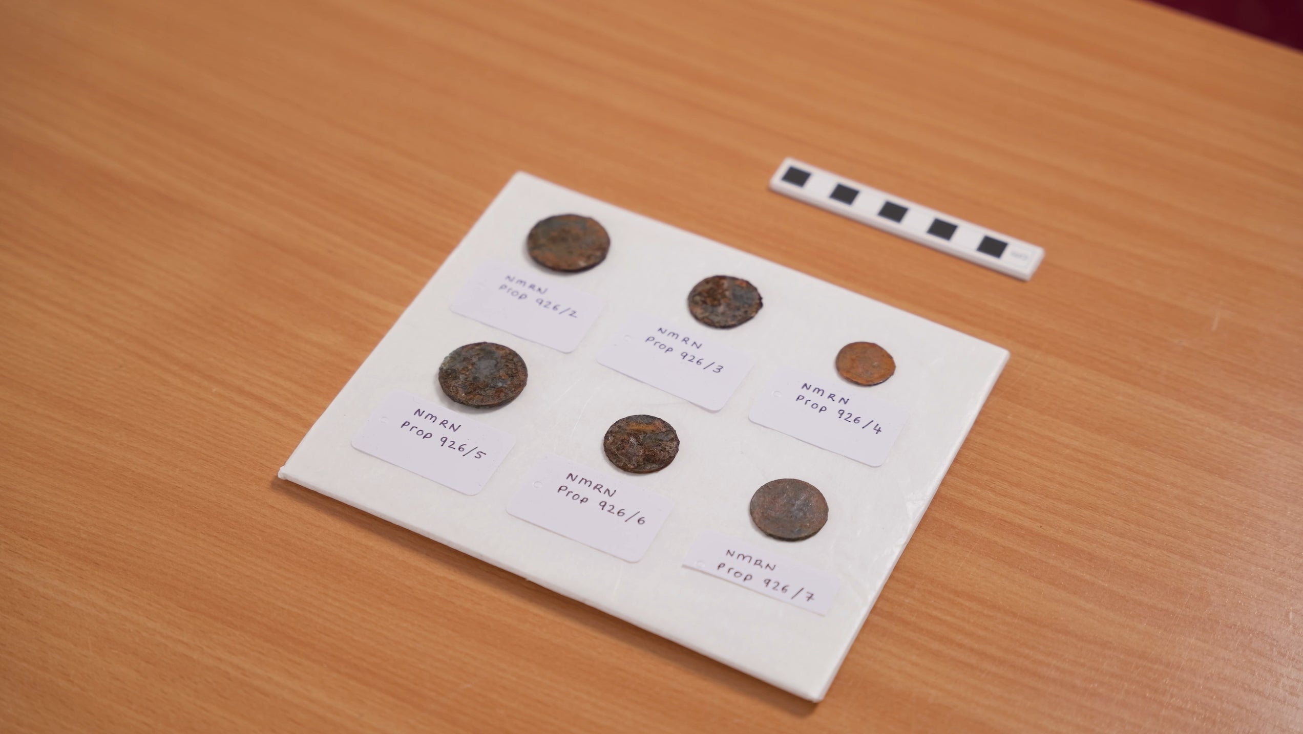 One of the coins has been identified as a token from Prince Edward Island, Canada, dated to 1835