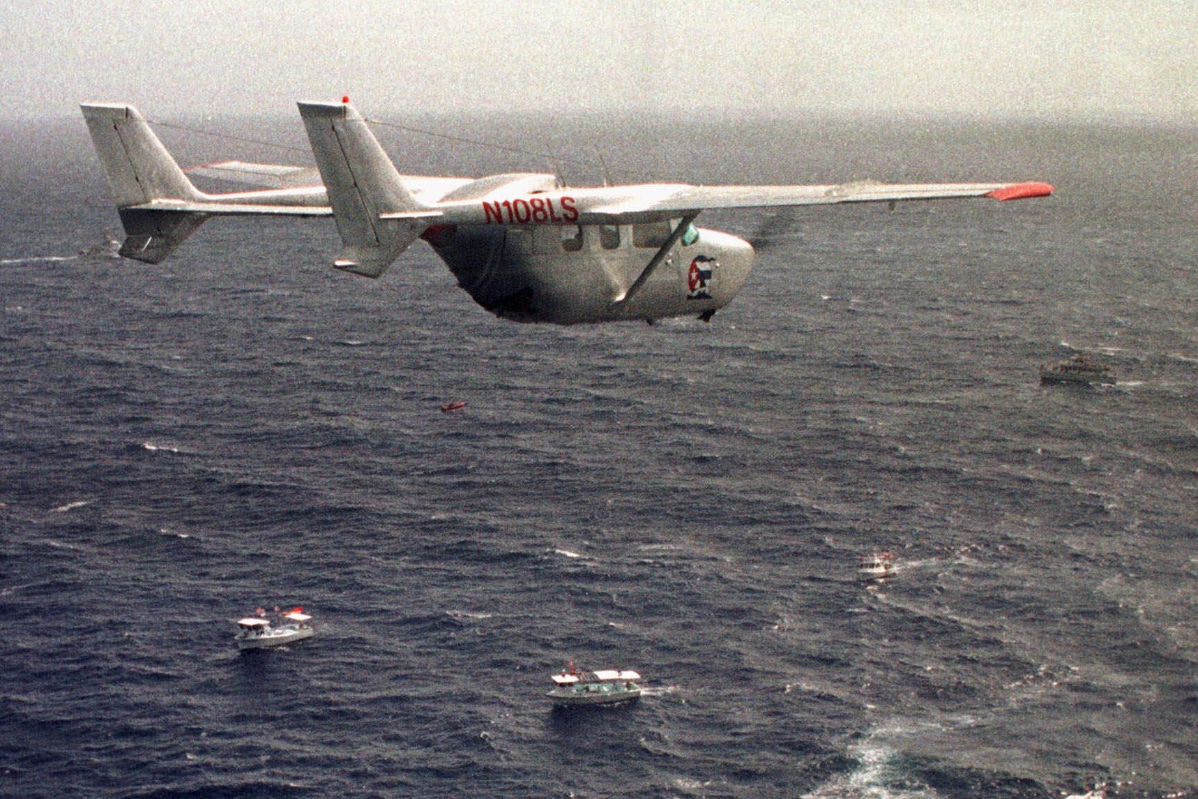 A Brothers to the Rescue plane flies over The Democracy Movement flotilla at the twelve-mile limit north of Havana, Cuba, July 10, 1999