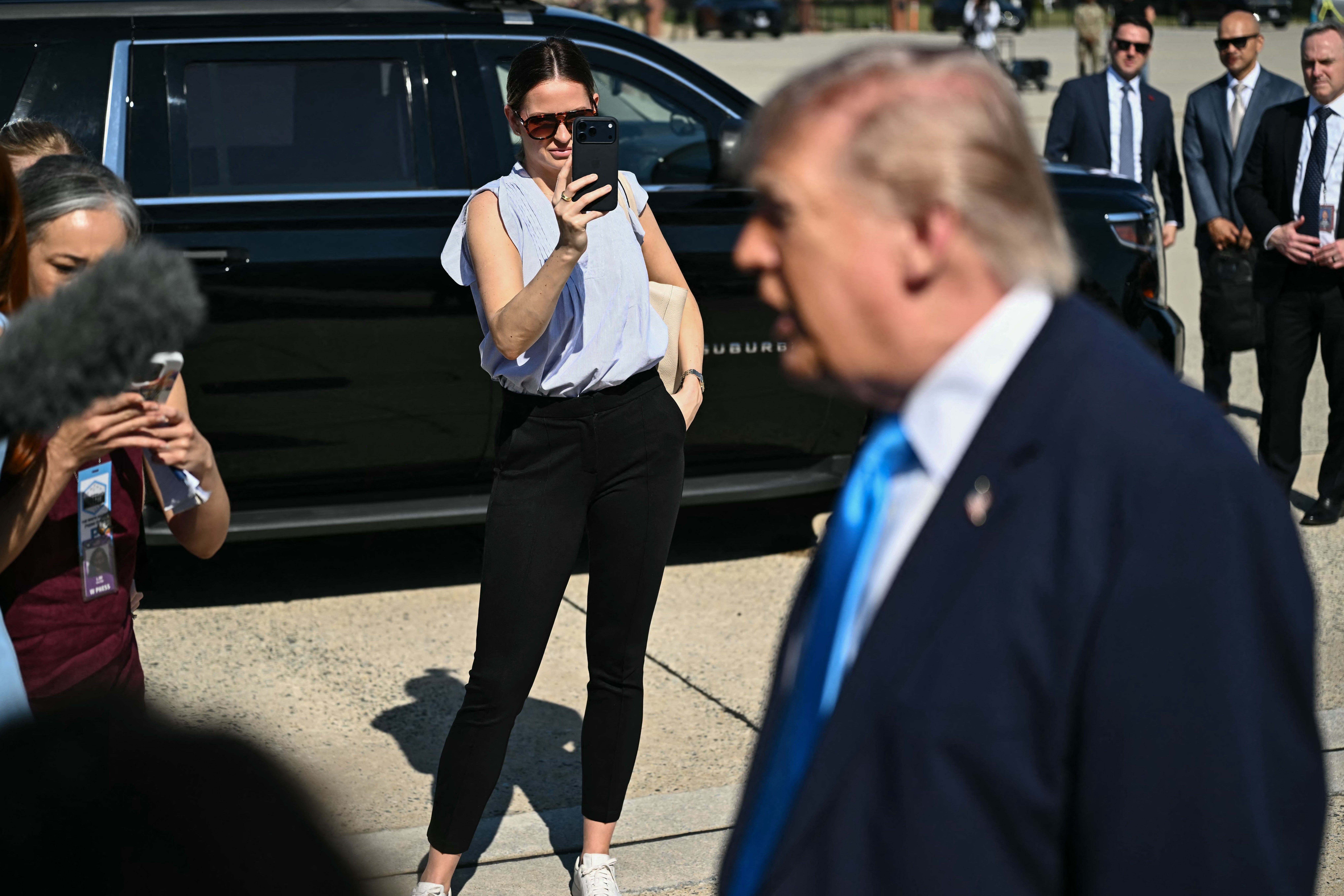 Margo Martin, Special Assistant to the President and Communications Advisor, takes video on her phone as US President Donald Trump speaks to reporters before boarding Air Force One at Joint Base Andrews, Maryland (AFP/Getty)