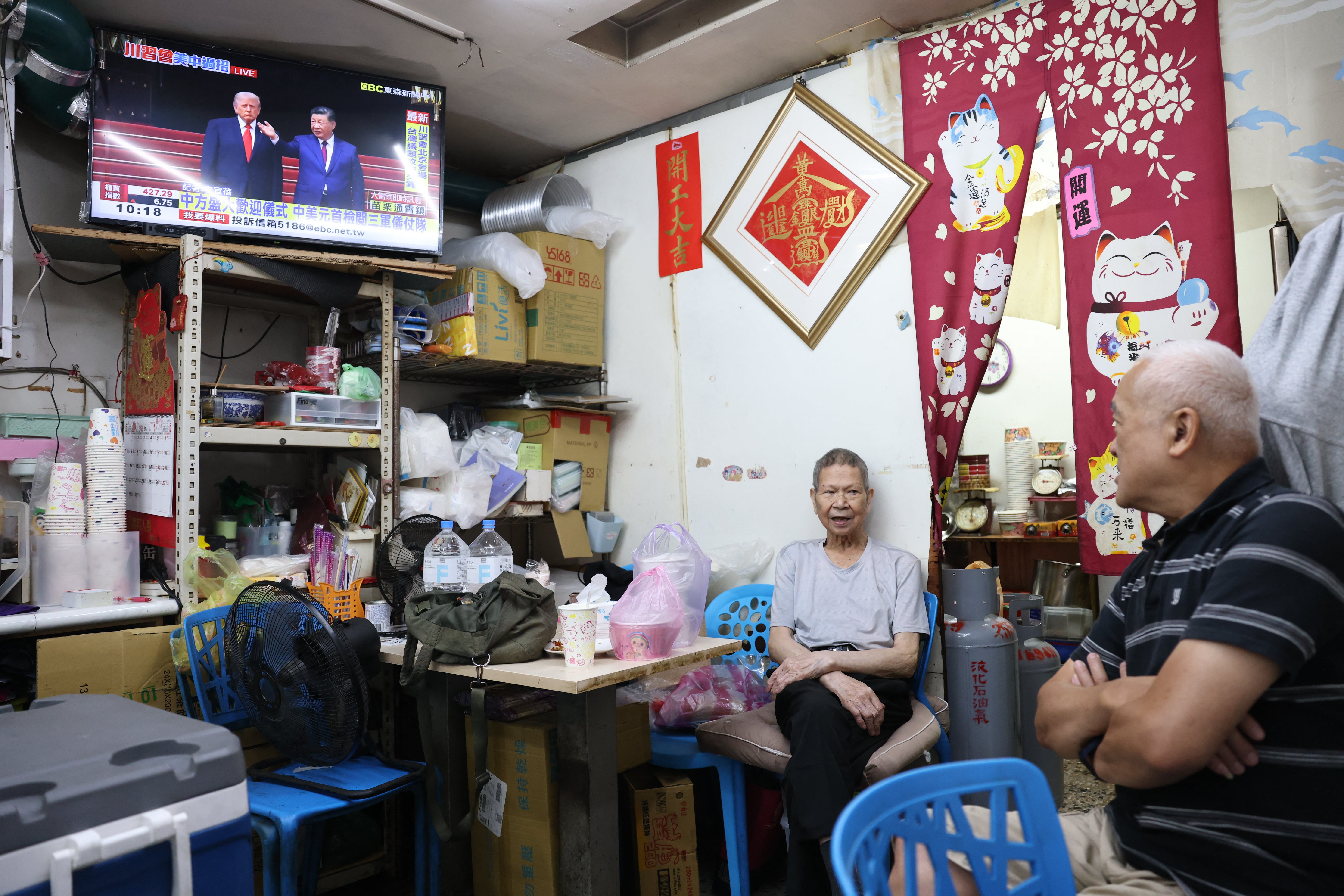 People in Taipei watch a telecast of Donald Trump's visit to China (AFP/Getty)