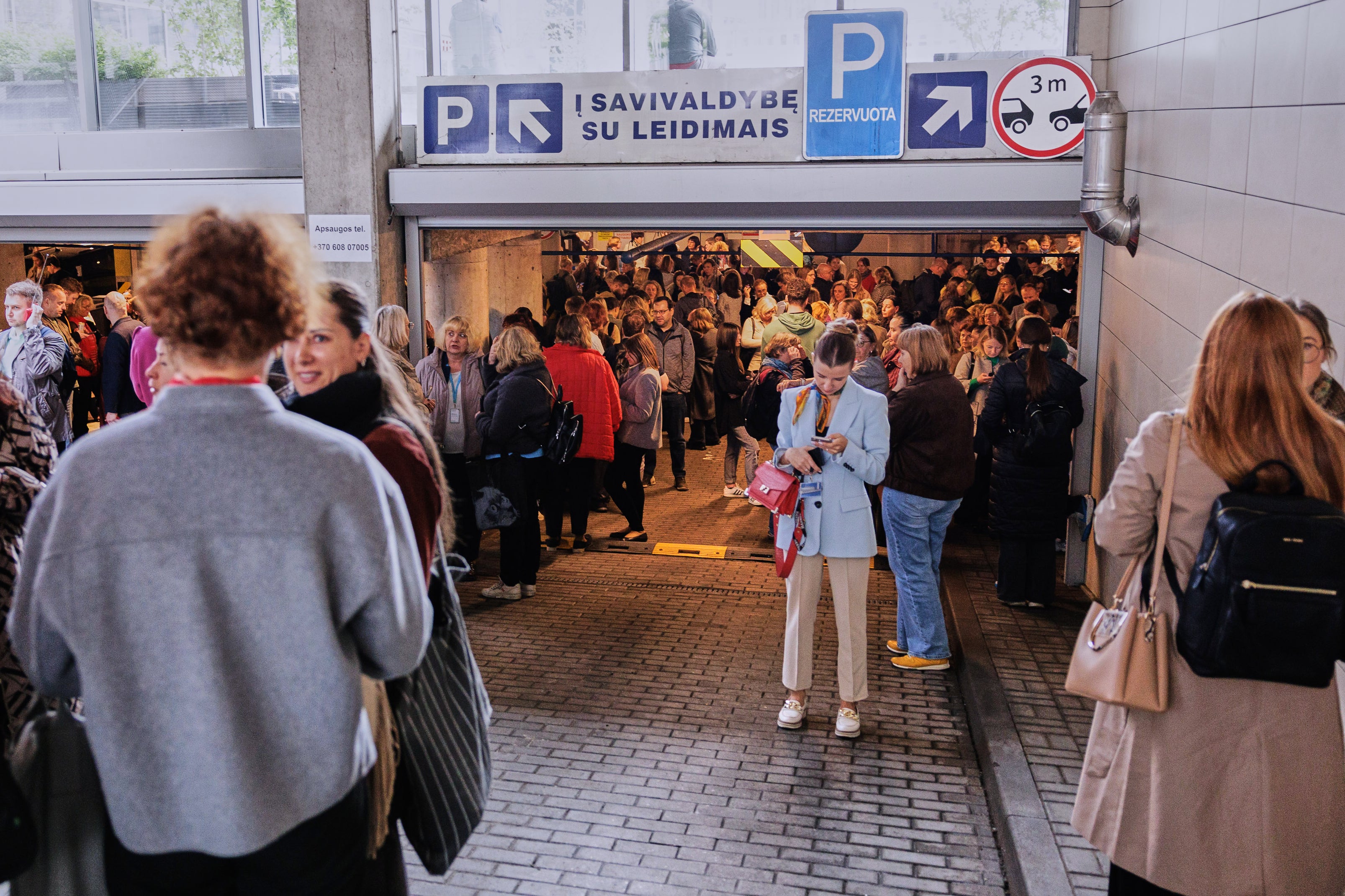 People take shelter in an underground car park during an air raid alert in Vilnius, Lithuania, Wednesday, May 20, 2026. (Vygintas Skaraitis/Lrytas via AP) (Copyright 2026 The Associated Press. All rights reserved)