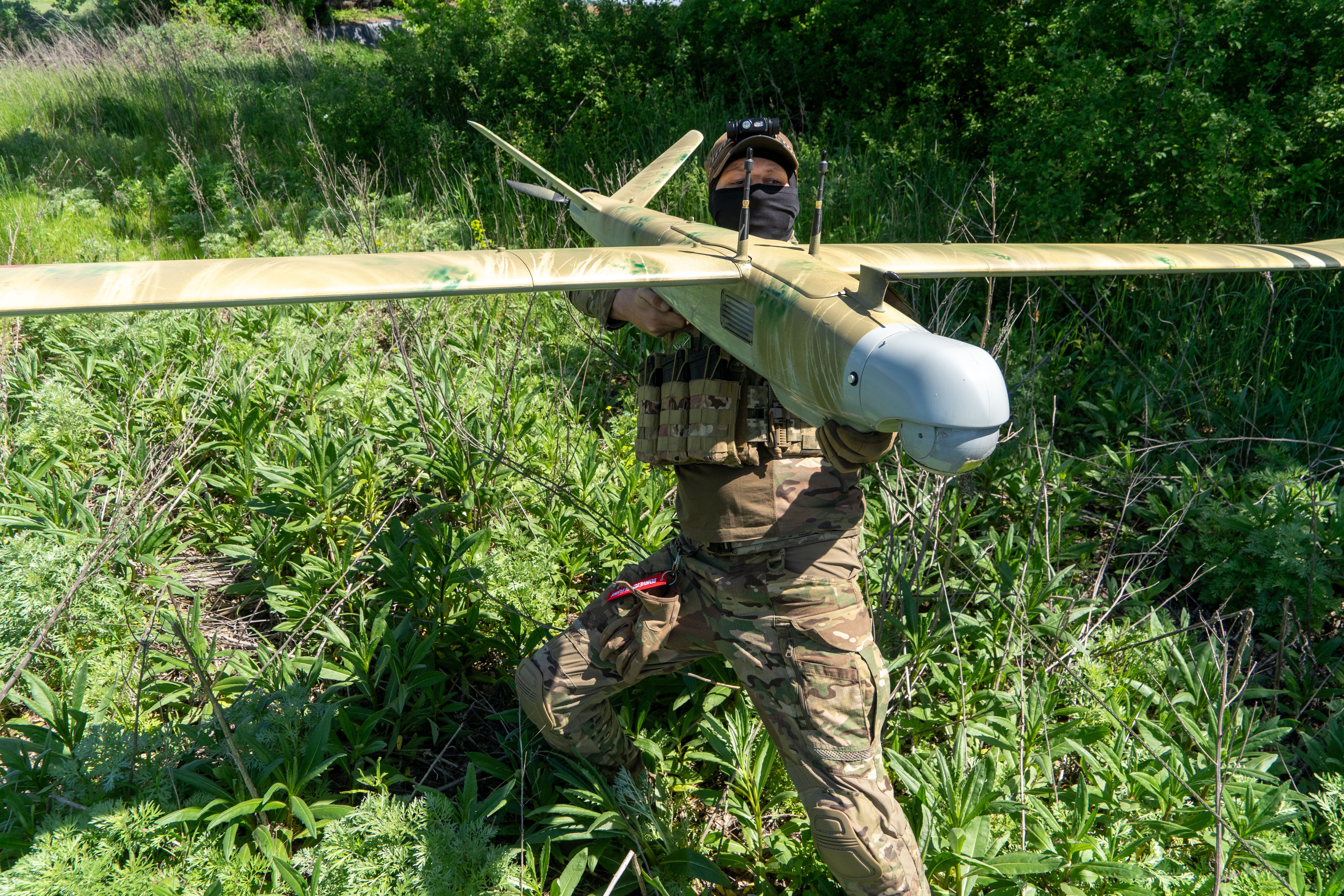A Ukrainian serviceman of Khartia brigade launches a drone towards Russian positions at the front line in the Kharkiv region (AP)