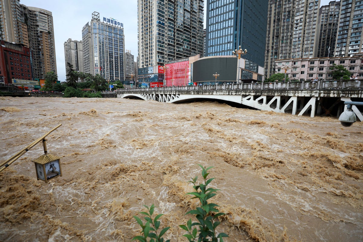 Rescuers swim through buildings to reach trapped residents as rains kill 24 in China