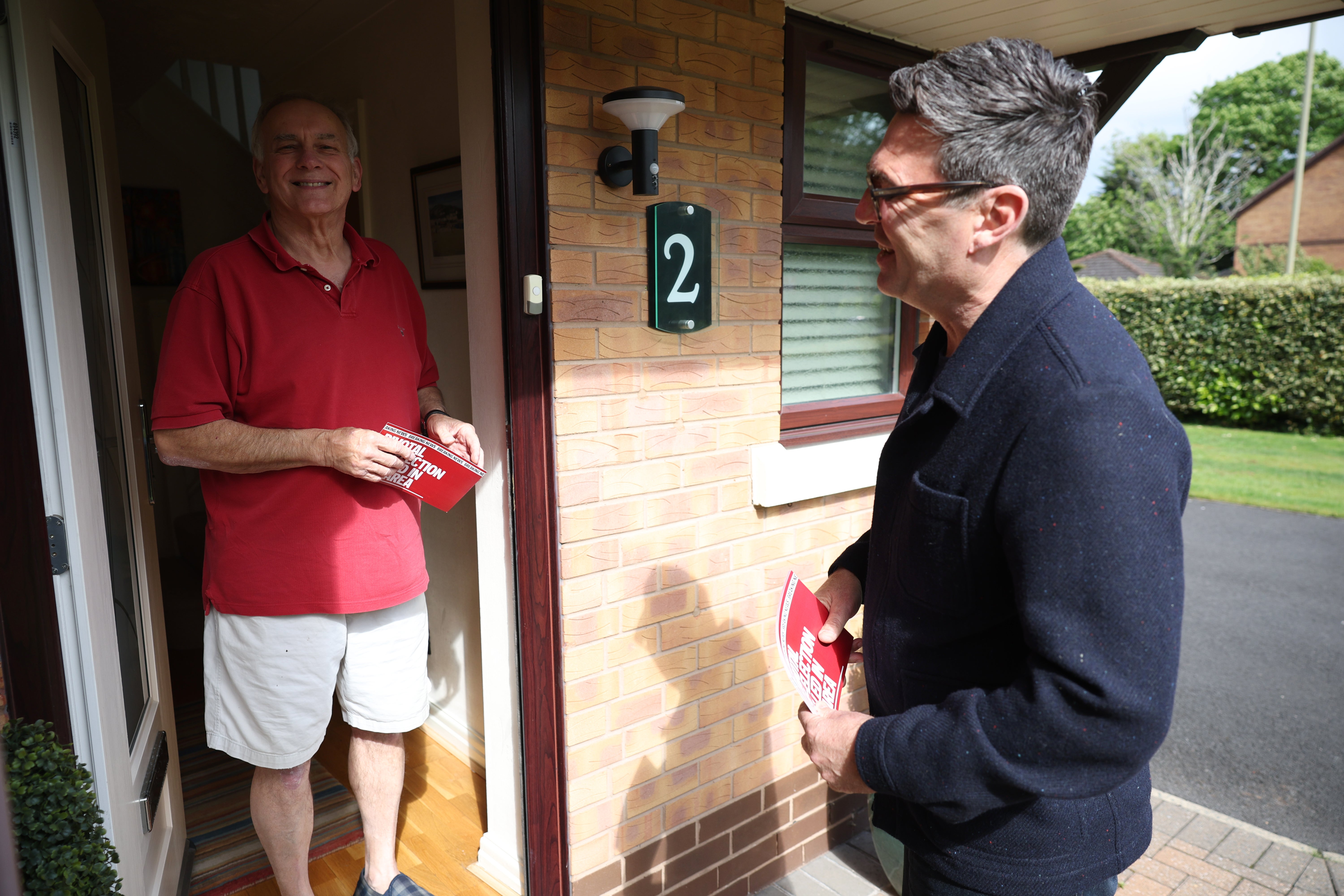 Andy Burnham, mayor of Greater Manchester, speaks with a local resident as he goes door to door (Getty)