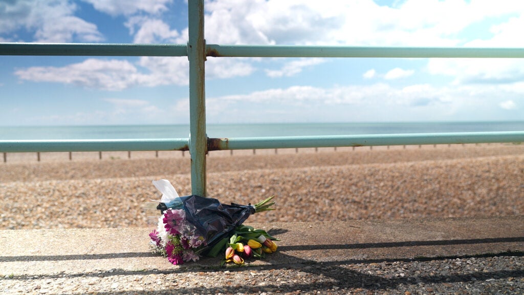 Flowers laid at the scene where the bodies of the three women were recovered from the sea off Brighton beach (Anahita Hossein-Pour/PA)