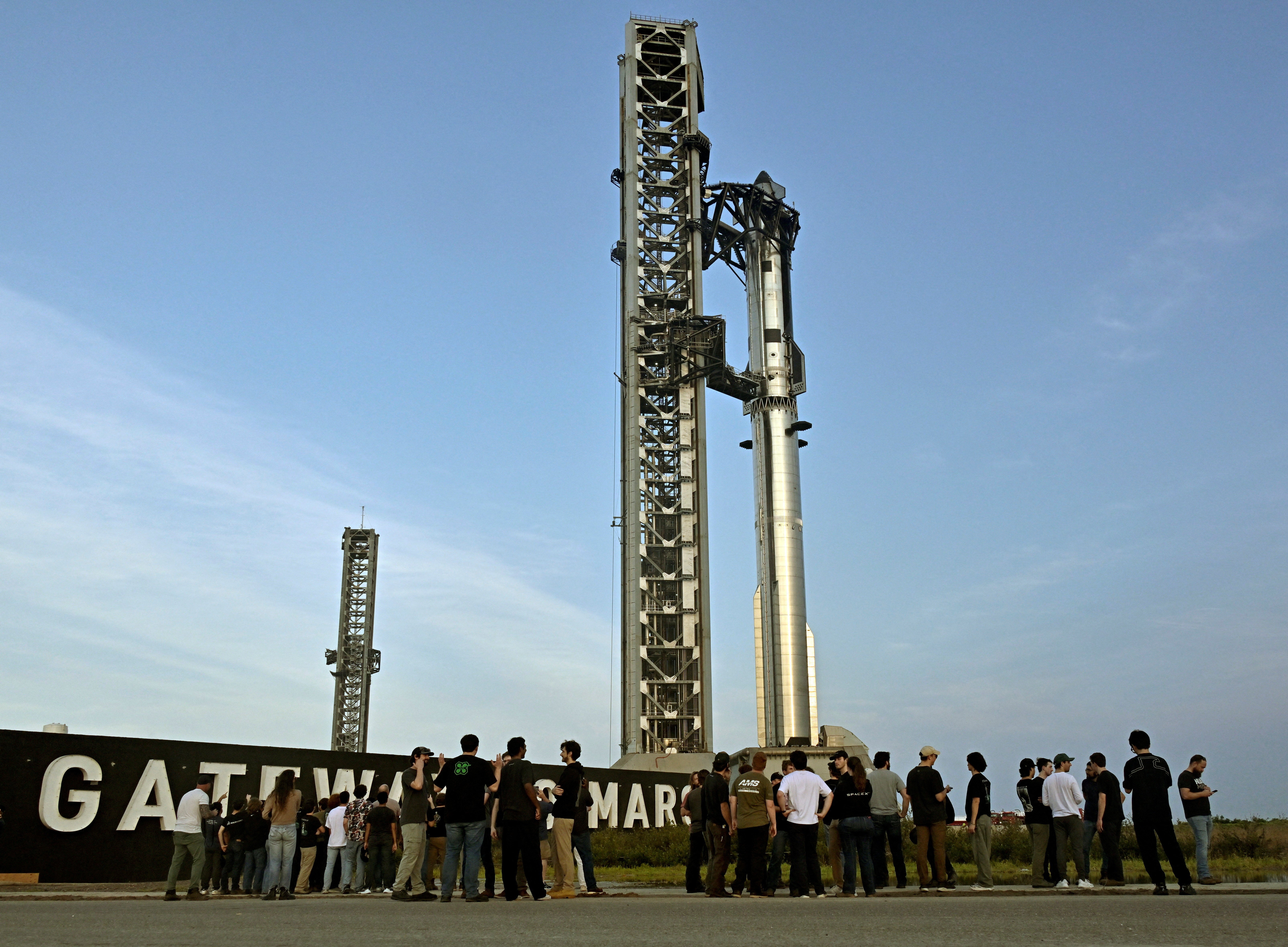 A crowd gathers near launch pad 2 to look at the SpaceX Starship spacecraft and the Super Heavy Booster as preparations continue for the 12th test flight of the Starship spacecraft in Starbase, Texas, on 20 May, 2026 (Reuters)