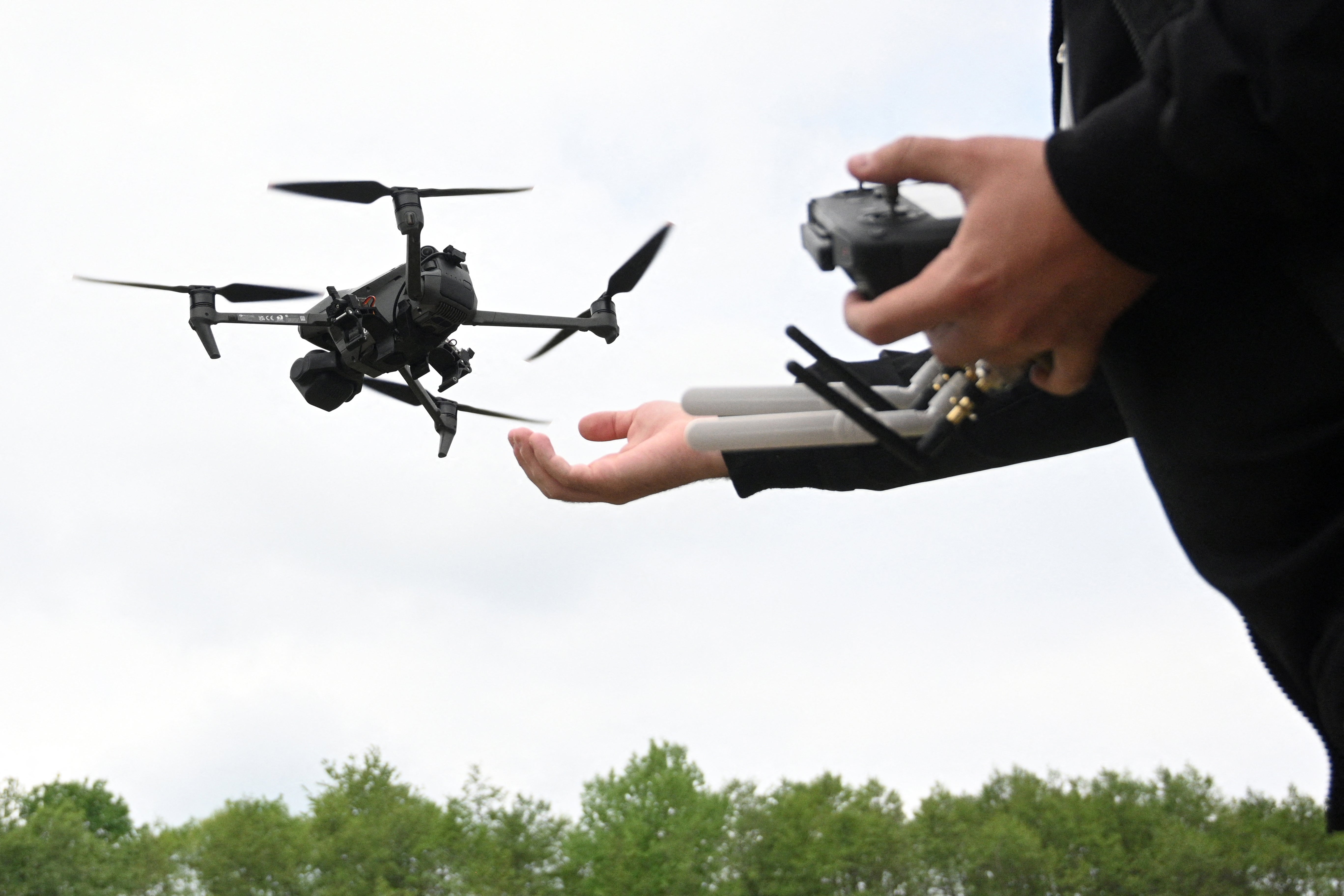 A man pilots a drone during the ‘Wild Drones’ racing competition designed to simulate battlefield conditions in Truskavets, Lviv region