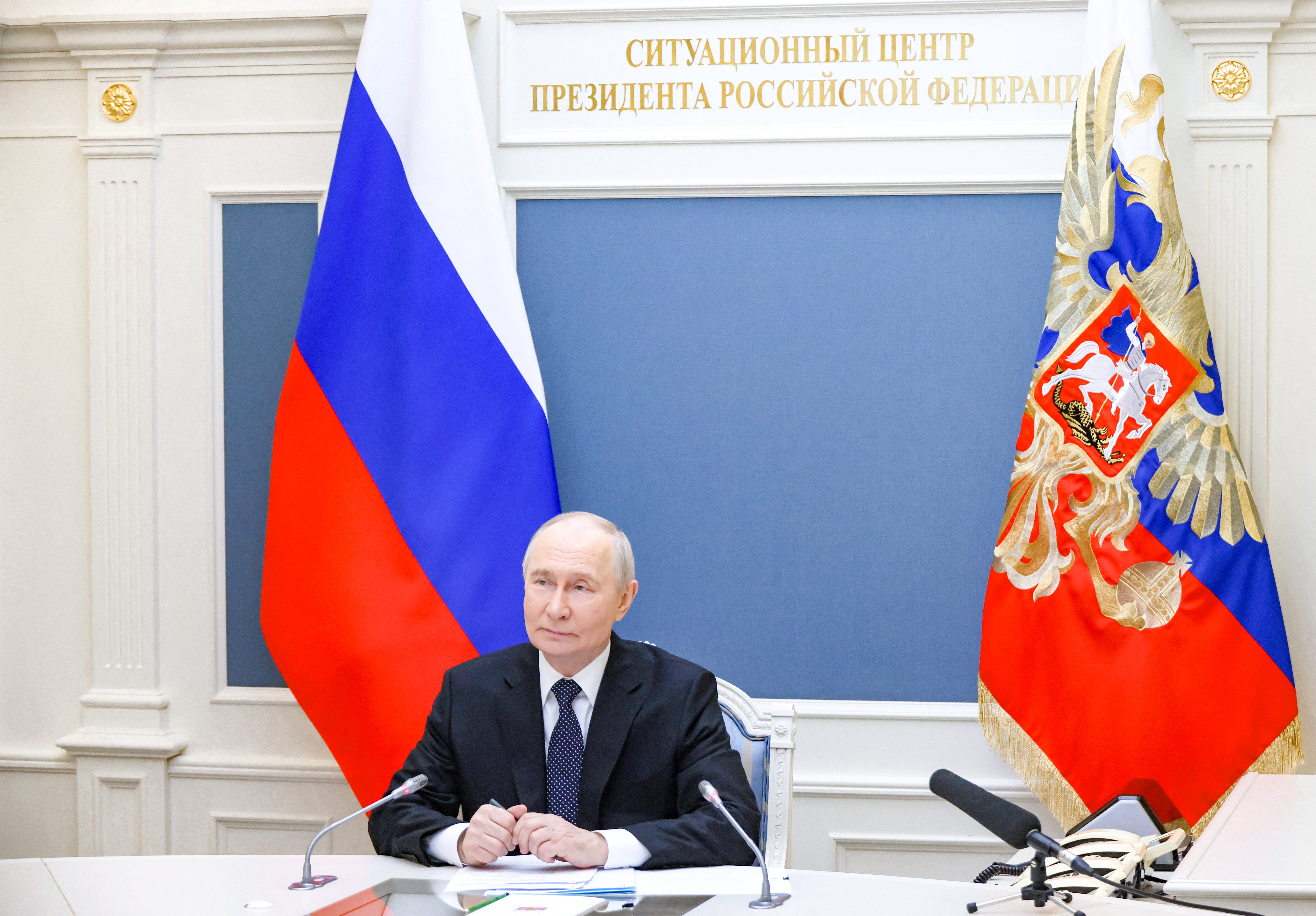 In this pool photograph distributed by the Russian state agency Sputnik, Russia's President Vladimir Putin oversees the joint Russian-Belarusian nuclear weapons drills along with Belarusian President, via a videolink in Moscow