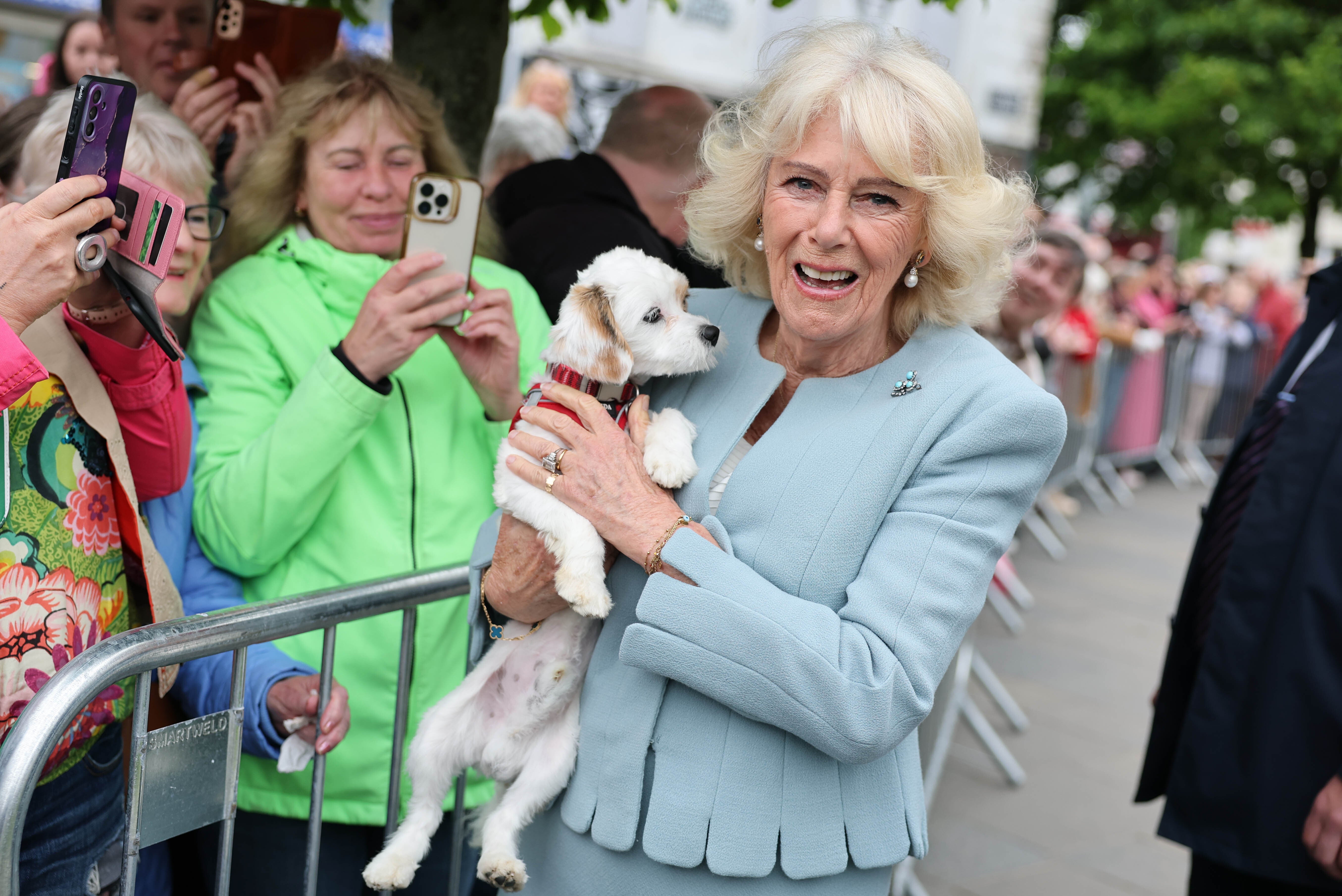 Camilla cuddled one well-wisher’s four-legged friend in Conway Square, Newtownards (Chris Jackson/PA)