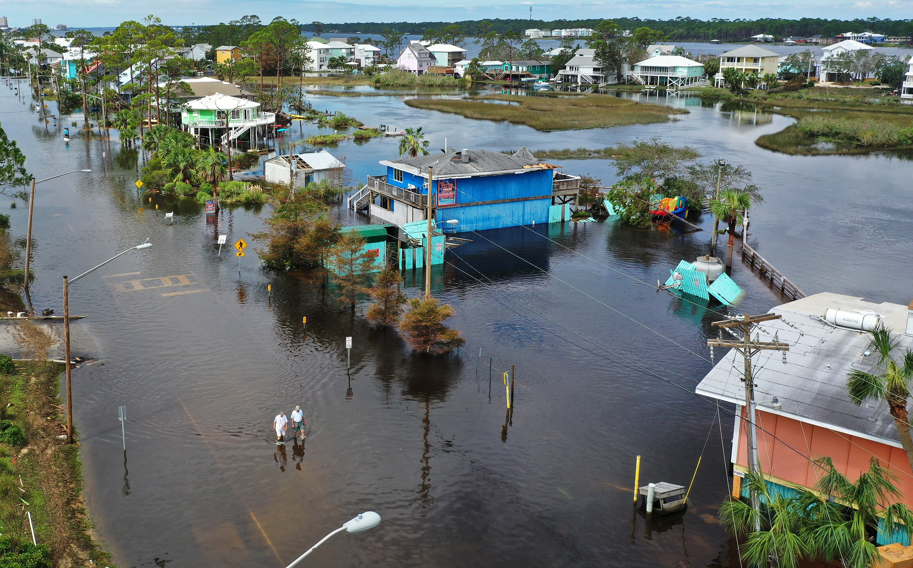 An aerial view from a drone shows people walking through a flooded street after Hurricane Sally hit Gulf Shores, Alabama, in September 2020. Last year was eerily quiet for Atlantic hurricanes making landfall in the U.S.
