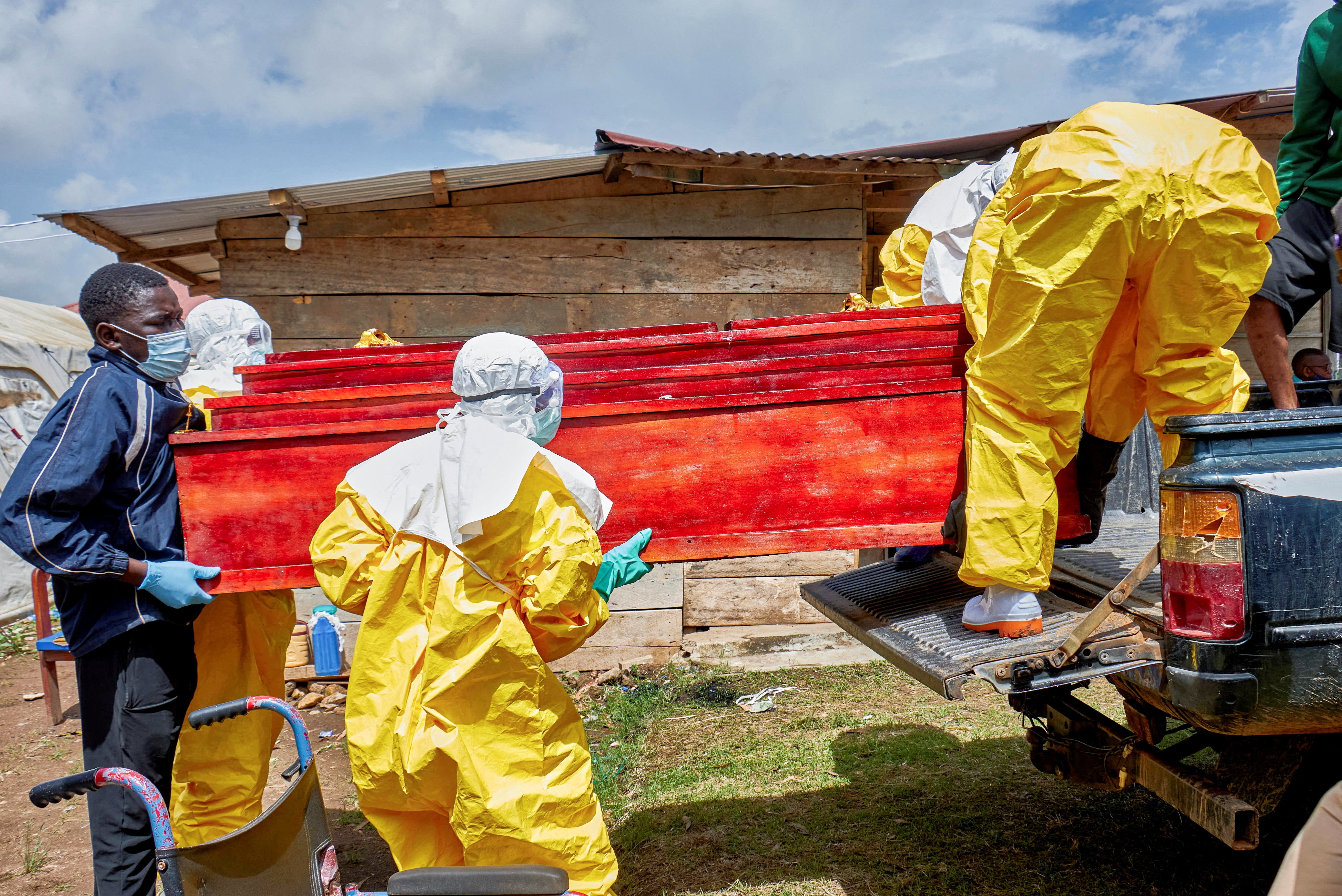 Red Cross workers carry the coffin with the body of a person who died of Ebola, as aid agencies intensify efforts to contain a new Ebola outbreak involving the Bundibugyo strain