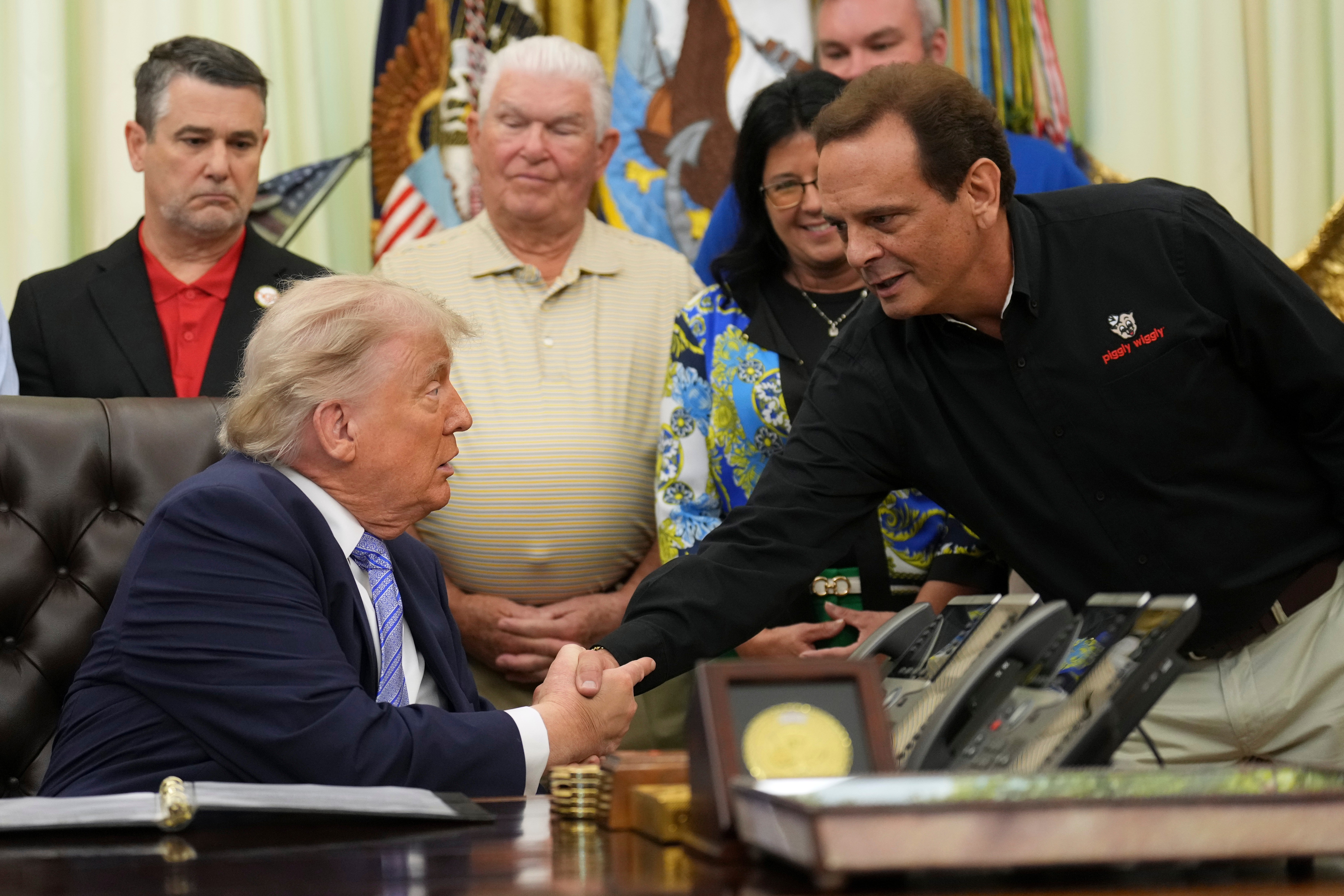 Trump shakes the hand of Kevin McDaniel, Piggly Wiggly franchise owner, during an event about loosening a federal refrigerant rule (AP Photo/Jacquelyn Martin)