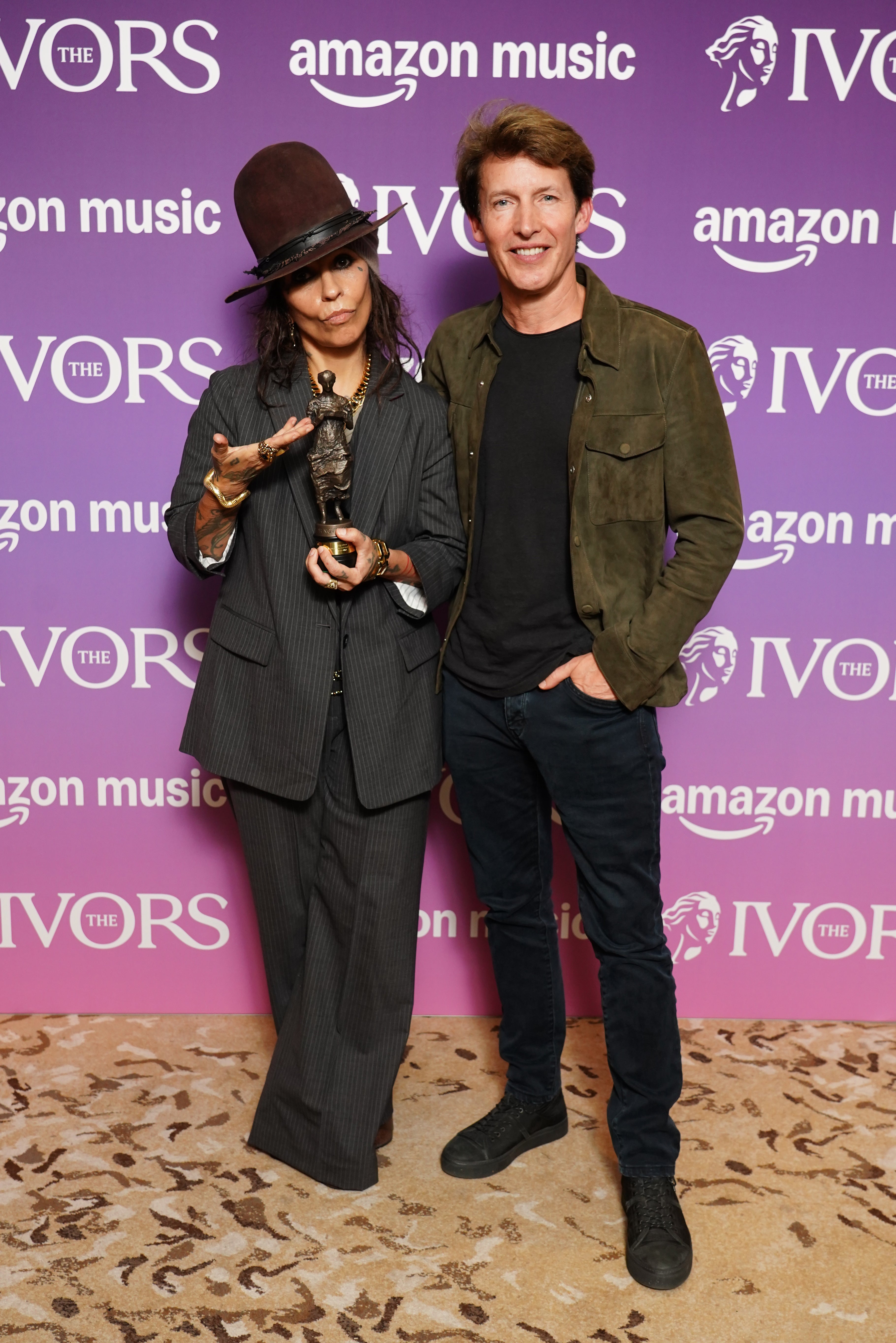 Linda Perry with her special international award and James Blunt (Ian West/PA) (PA Wire)