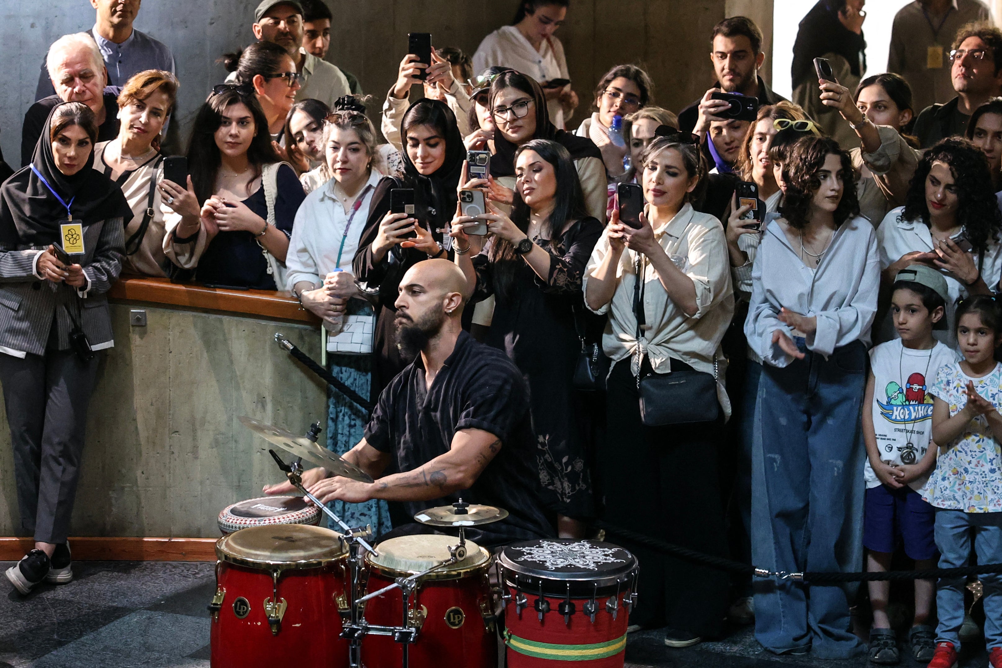 Spectators take photographs as an Iranian artist performs traditional southern music at Tehran's Museum of Contemporary Art (AFP/Getty)