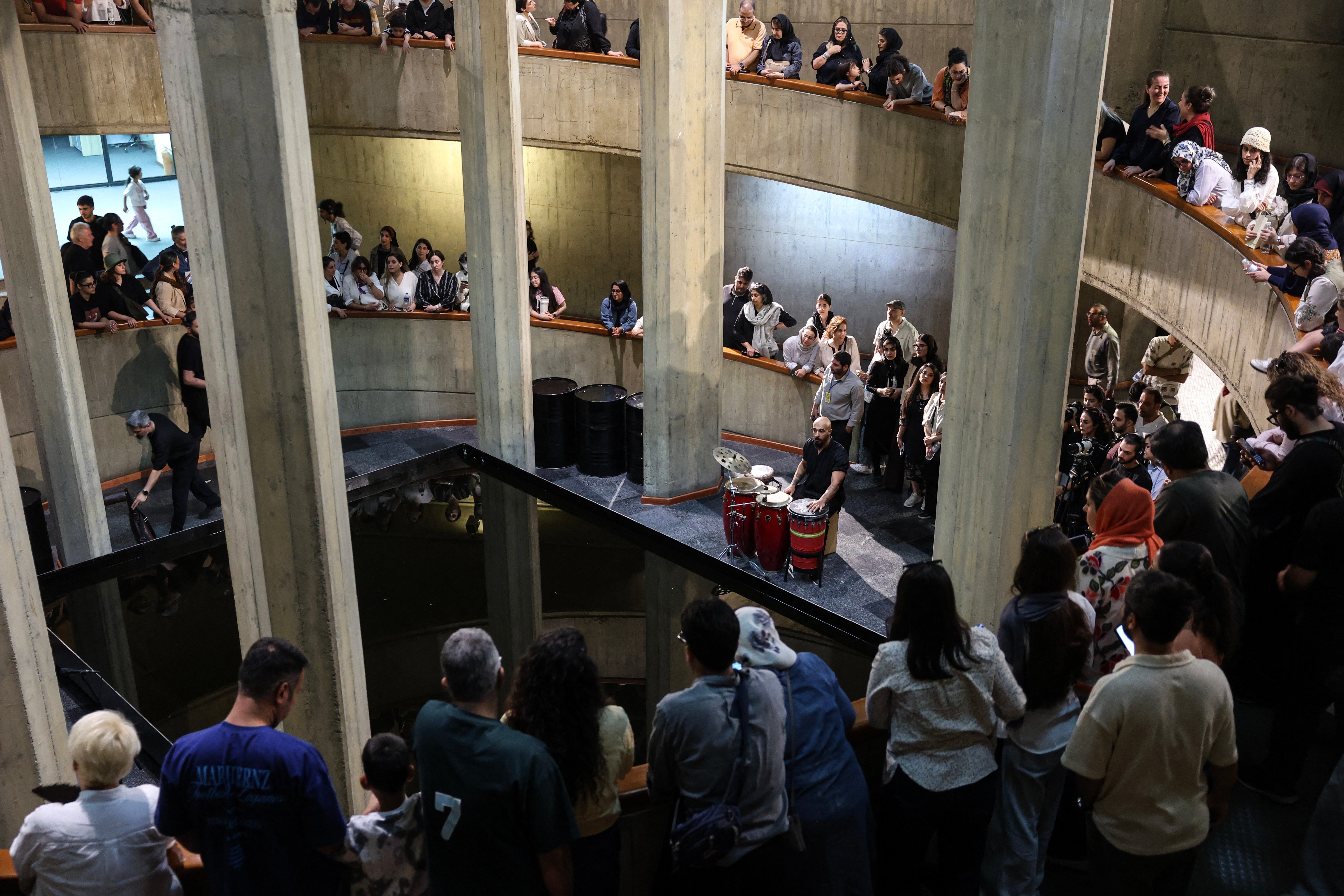 People watch as an Iranian artist performs traditional southern music at Tehran's Museum of Contemporary Art (AFP/Getty)