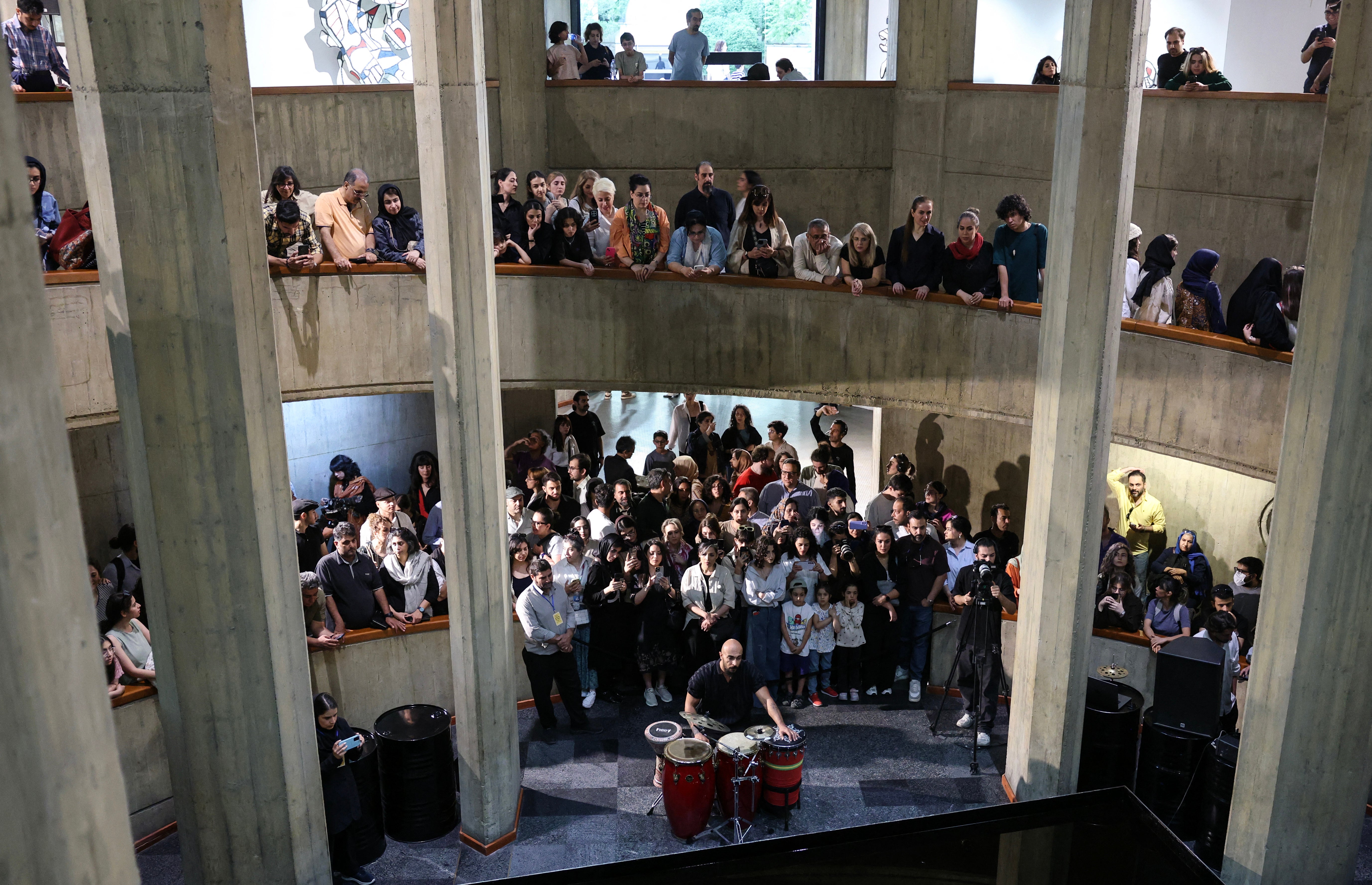 People watch as an Iranian artist performs traditional southern music at Tehran's Museum of Contemporary Art (AFP/Getty)
